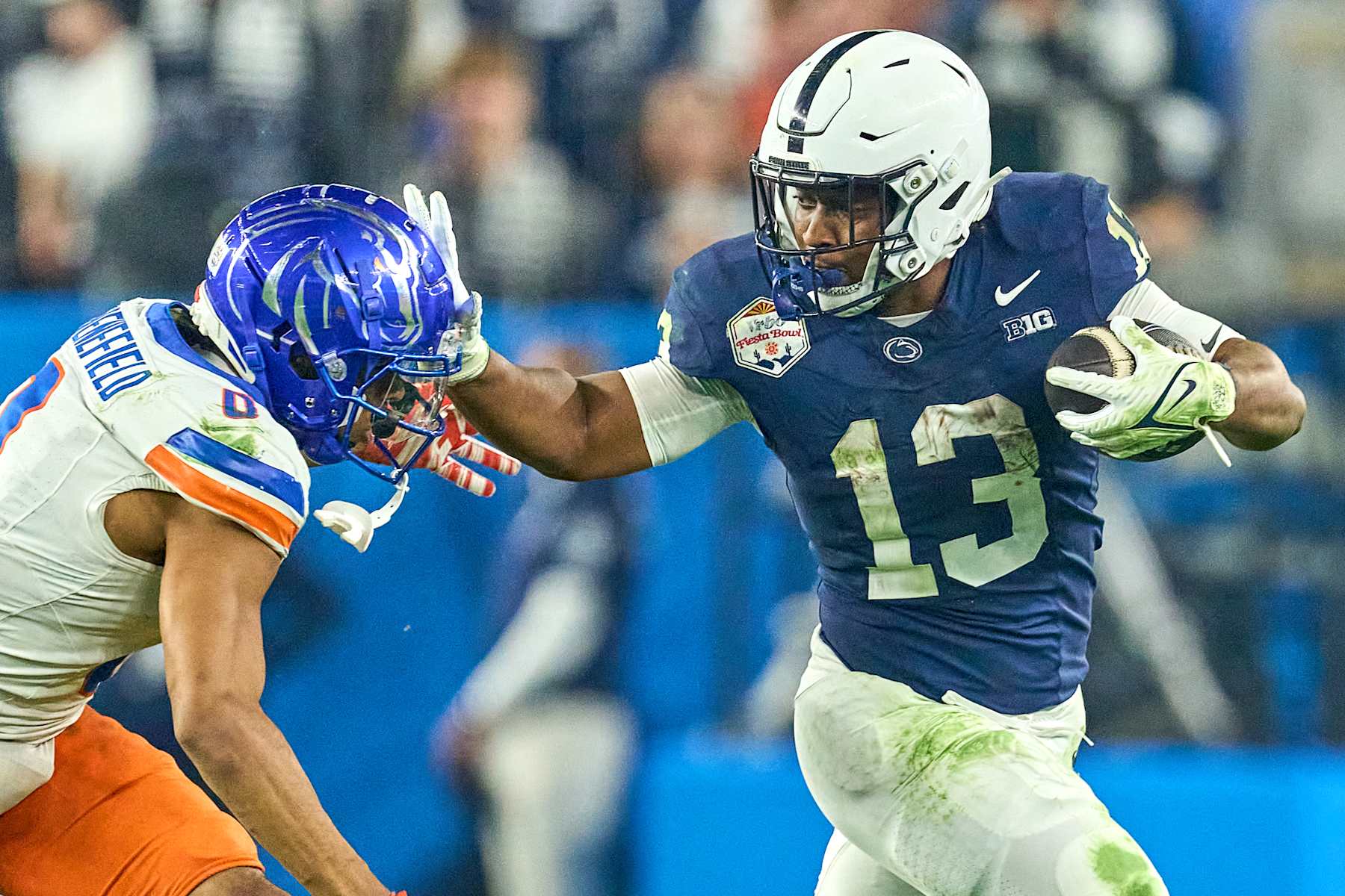 GLENDALE, ARIZONA - DECEMBER 31: Penn State Nittany Lions running back Kaytron Allen (13) runs with the football and battles with Boise State Broncos cornerback Markel Reed (8) in action during the 2024 Vrbo Fiesta Bowl between the Penn State Nittany Lions and Boise State Broncos at State Farm Stadium on December 31, 2024 in Glendale, Arizona. (Photo by Robin Alam/ISI Photos/Getty Images)