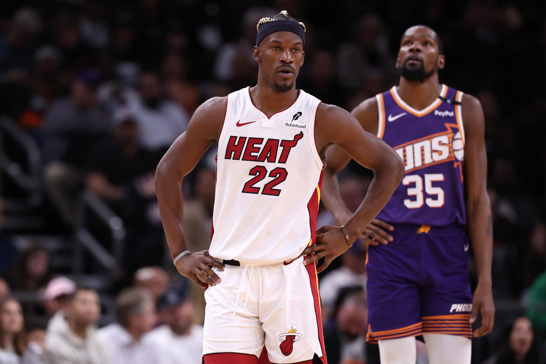 PHOENIX, ARIZONA - NOVEMBER 06: Jimmy Butler #22 of the Miami Heat and Kevin Durant #35 of the Phoenix Suns looks on during the game at Footprint Center on November 06, 2024 in Phoenix, Arizona. The Suns defeated the Heat 115-112. NOTE TO USER: User expressly acknowledges and agrees that, by downloading and or using this photograph, User is consenting to the terms and conditions of the Getty Images License Agreement.  (Photo by Chris Coduto/Getty Images)