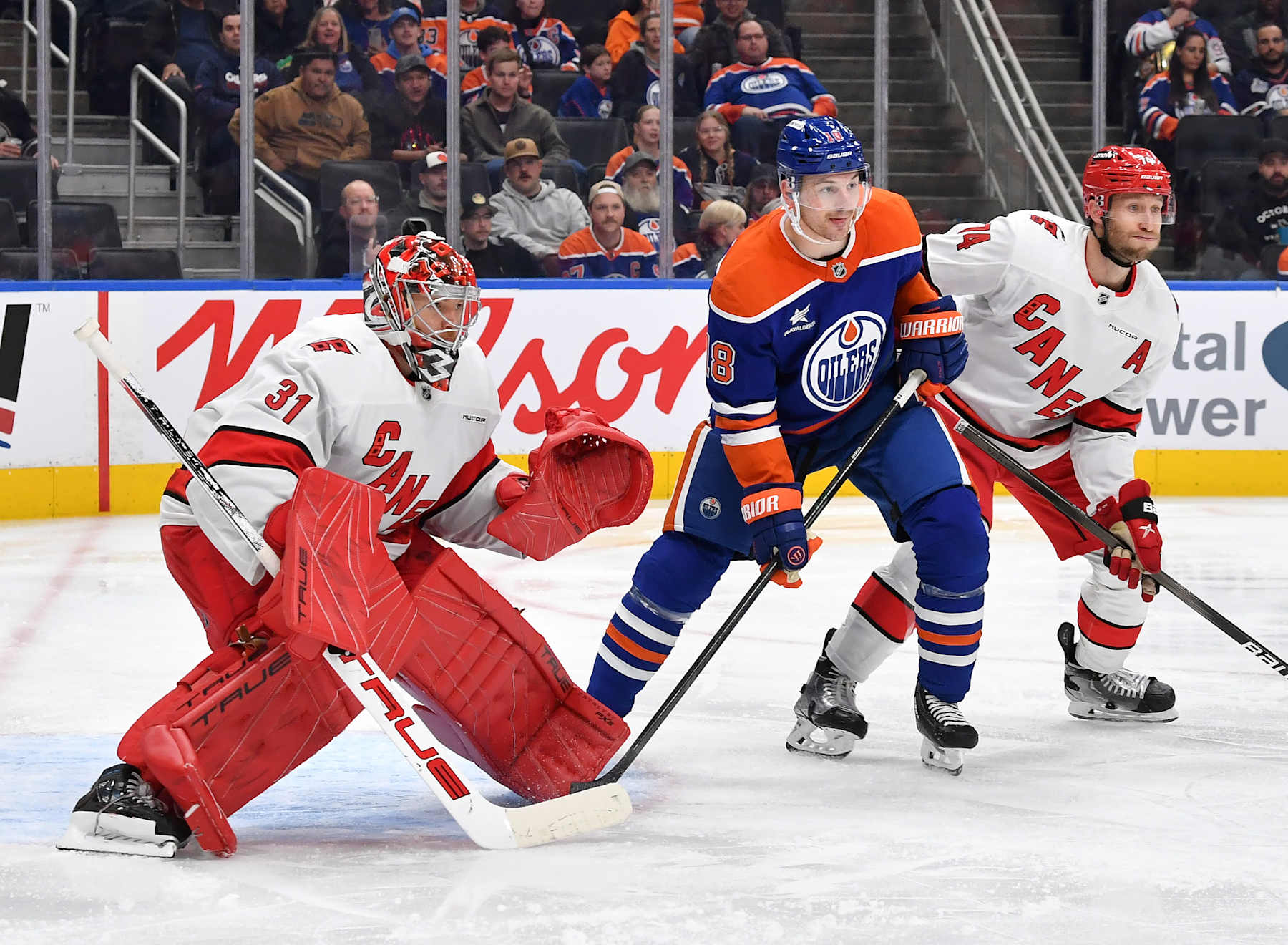 EDMONTON, CANADA - OCTOBER 22: Zach Hyman #18 of the Edmonton Oilers battles for position against Jaccob Slavin #74 of the Carolina Hurricanes as Frederik Andersen #31 tracks the puck during the second period of the game at Rogers Place on October 22, 2024, in Edmonton, Alberta, Canada. (Photo by Andy Devlin/NHLI via Getty Images)