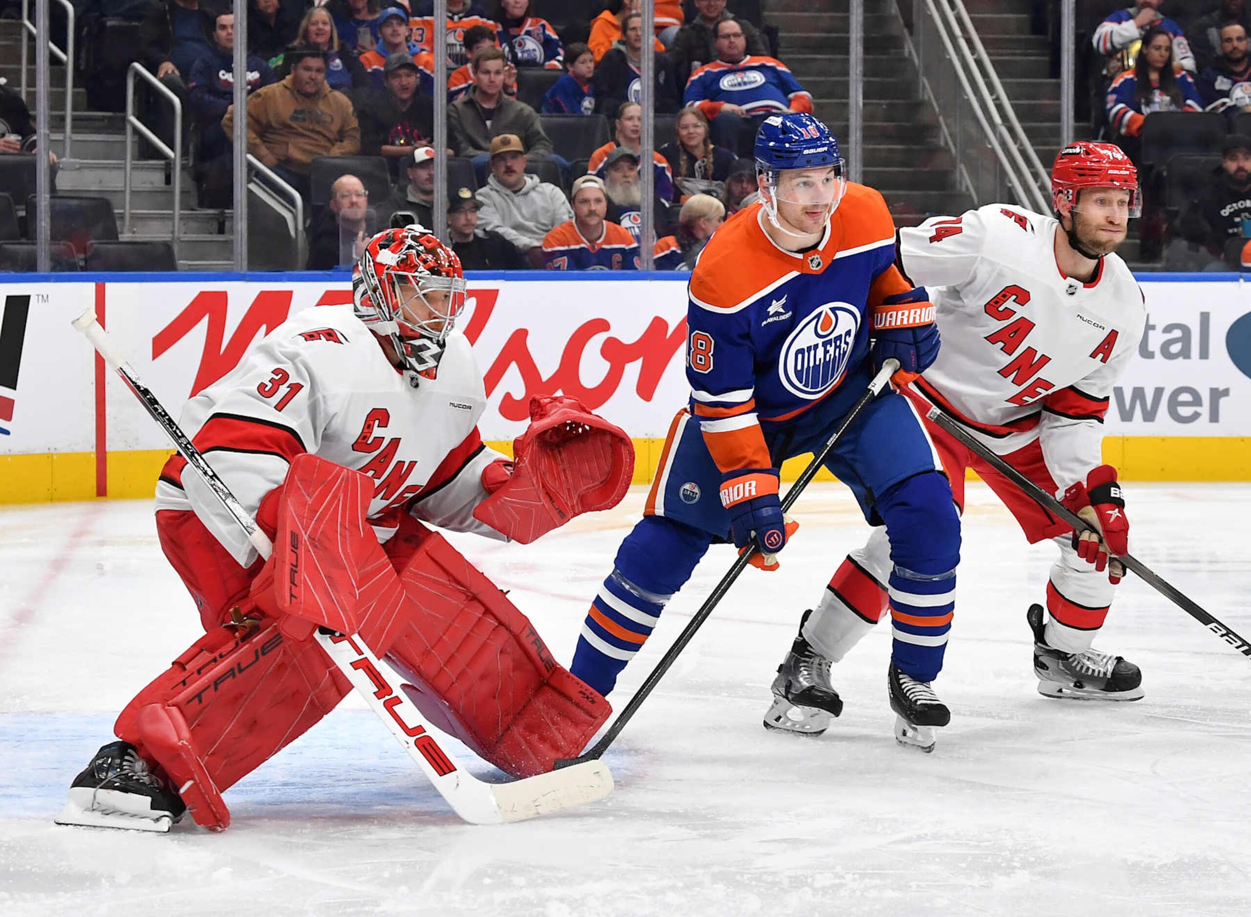 EDMONTON, CANADA - OCTOBER 22: Zach Hyman #18 of the Edmonton Oilers battles for position against Jaccob Slavin #74 of the Carolina Hurricanes as Frederik Andersen #31 tracks the puck during the second period of the game at Rogers Place on October 22, 2024, in Edmonton, Alberta, Canada. (Photo by Andy Devlin/NHLI via Getty Images) EDMONTON, CANADA - OCTOBER 22: Zach Hyman #18 of the Edmonton Oilers battles for position against Jaccob Slavin #74 of the Carolina Hurricanes as Frederik Andersen #31 tracks the puck during the second period of the game at Rogers Place on October 22, 2024, in Edmonton, Alberta, Canada. (Photo by Andy Devlin/NHLI via Getty Images)