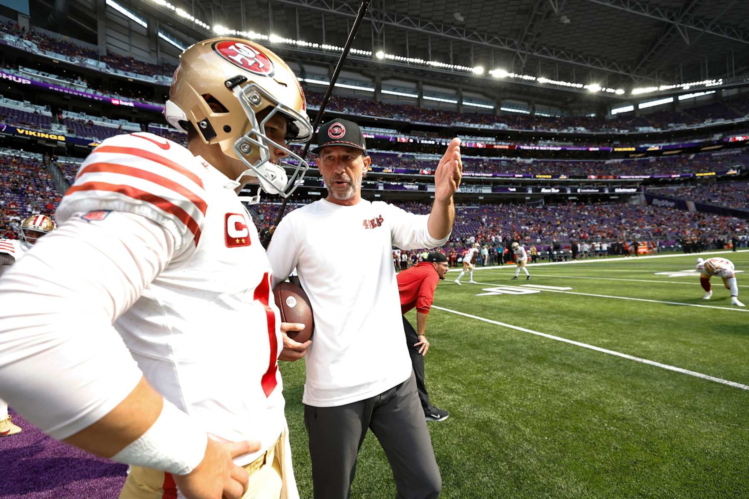 MINNEAPOLIS, MN - SEPTEMBER 15: Brock Purdy #13 and Head Coach Kyle Shanahan of the San Francisco 49ers before the game against the Minnesota Vikings at U.S. Bank Stadium on September 15, 2024 in Minneapolis, Minnesota. The Vikings defeated the 49ers 23-17. (Photo by Michael Zagaris/San Francisco 49ers/Getty Images) MINNEAPOLIS, MN - SEPTEMBER 15: Brock Purdy #13 and Head Coach Kyle Shanahan of the San Francisco 49ers before the game against the Minnesota Vikings at U.S. Bank Stadium on September 15, 2024 in Minneapolis, Minnesota. The Vikings defeated the 49ers 23-17. (Photo by Michael Zagaris/San Francisco 49ers/Getty Images)