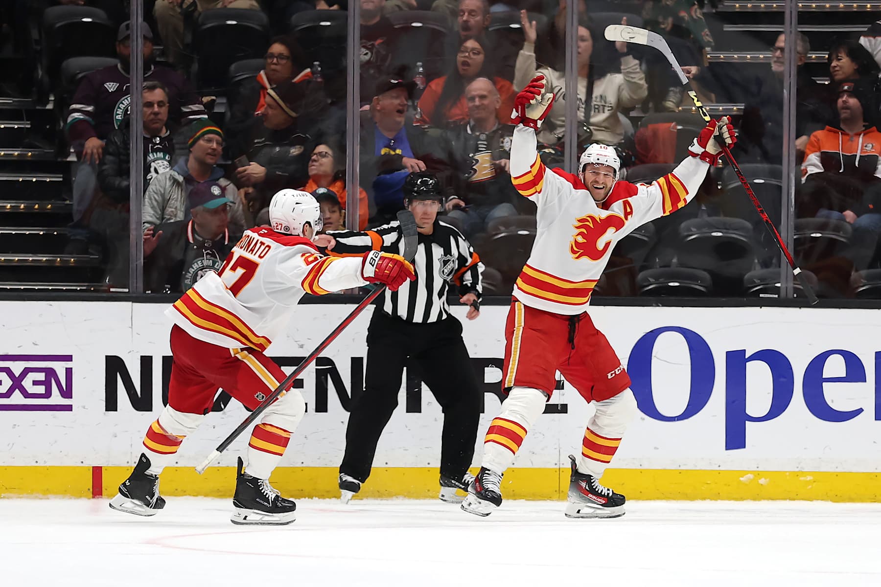 ANAHEIM, CALIFORNIA - JANUARY 07: Matt Coronato #27 congratulates Jonathan Huberdeau #10 of the Calgary Flames after his goal during overtime of a game against the Anaheim Ducks at Honda Center on January 07, 2025 in Anaheim, California. (Photo by Sean M. Haffey/Getty Images)