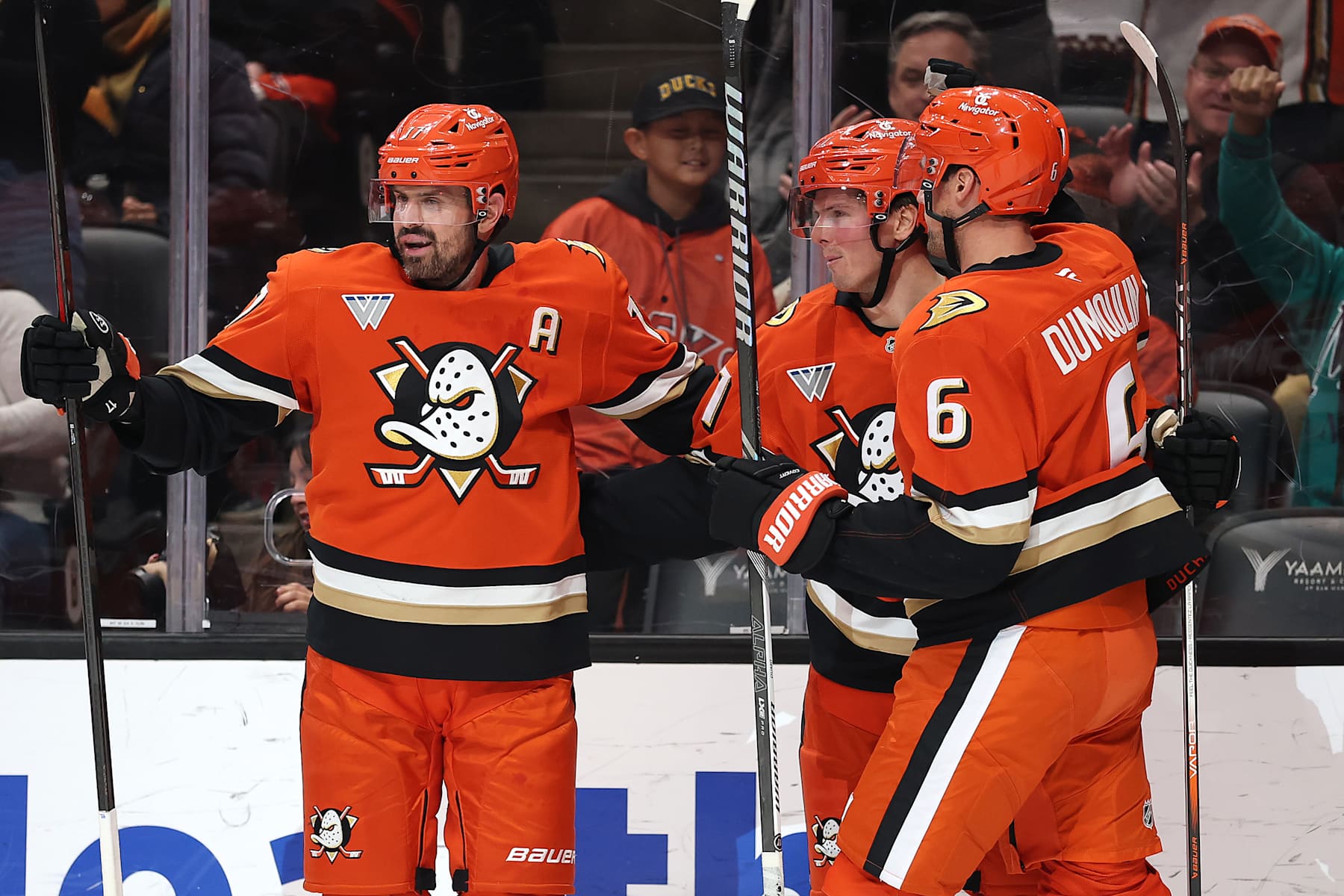 ANAHEIM, CALIFORNIA - JANUARY 07: Brian Dumoulin #6 and Isac Lundestrom #21 congratulate Alex Killorn #17 of the Anaheim Ducks after his goal during the second period of a game against the Calgary Flames at Honda Center on January 07, 2025 in Anaheim, California. (Photo by Sean M. Haffey/Getty Images)