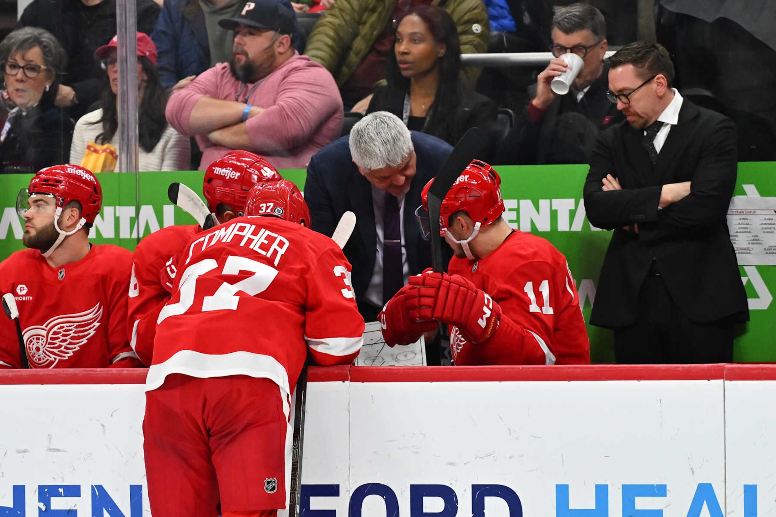 DETROIT, MI - JANUARY 07: Detroit Red Wings head coach Todd McLellan talks to Detroit Red Wings left wing J.T. Compher (37) and Detroit Red Wings right wing Vladimir Tarasenko (11) during a break during the game between the Detroit Red Wings and the Ottawa Senators Tuesday January 7, 2025 at Little Caesars Arena in Detroit, MI. (Photo by Steven King/Icon Sportswire via Getty Images) DETROIT, MI - JANUARY 07: Detroit Red Wings head coach Todd McLellan talks to Detroit Red Wings left wing J.T. Compher (37) and Detroit Red Wings right wing Vladimir Tarasenko (11) during a break during the game between the Detroit Red Wings and the Ottawa Senators Tuesday January 7, 2025 at Little Caesars Arena in Detroit, MI. (Photo by Steven King/Icon Sportswire via Getty Images)