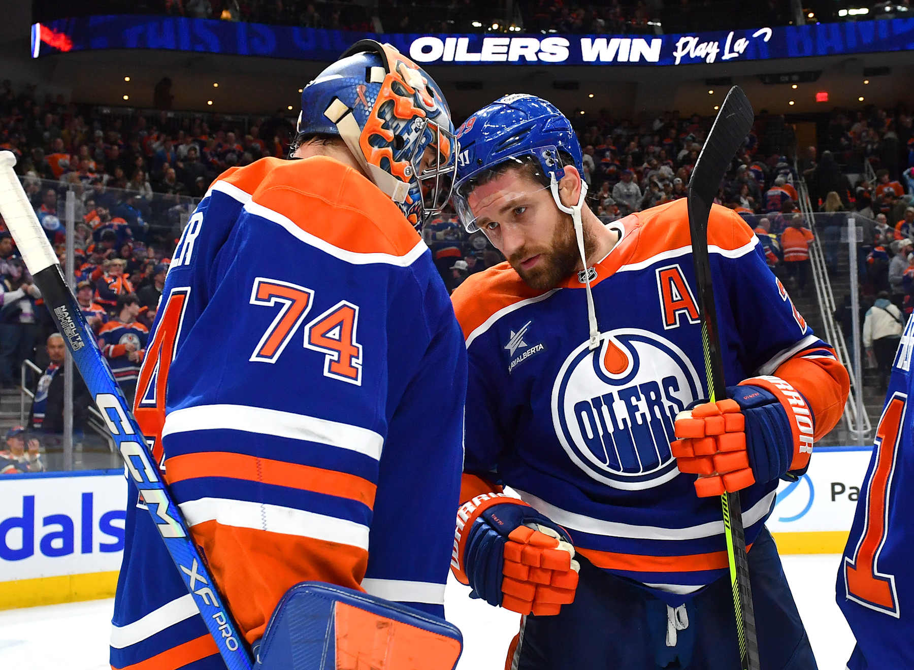 EDMONTON, CANADA - DECEMBER 31: Leon Draisaitl #29 and Stuart Skinner #74 of the Edmonton Oilers celebrate a victory over the Utah Hockey Club after the game at Rogers Place on December 31, 2024, in Edmonton, Alberta, Canada. (Photo by Andy Devlin/NHLI via Getty Images)