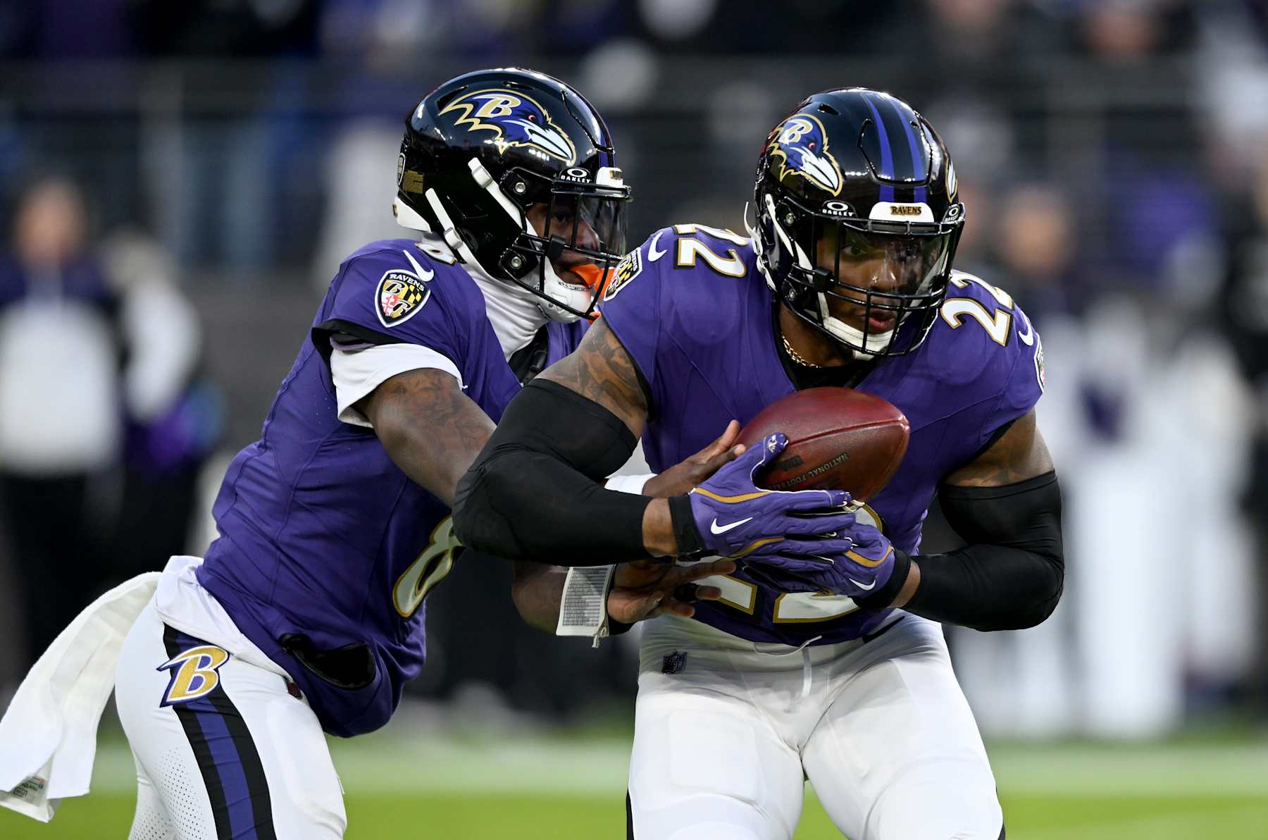 BALTIMORE, MARYLAND - JANUARY 04: Lamar Jackson #8 of the Baltimore Ravens hands the ball off to Derrick Henry #22 during the game against the Cleveland Browns at M&T Bank Stadium on January 04, 2025 in Baltimore, Maryland. (Photo by G Fiume/Getty Images)