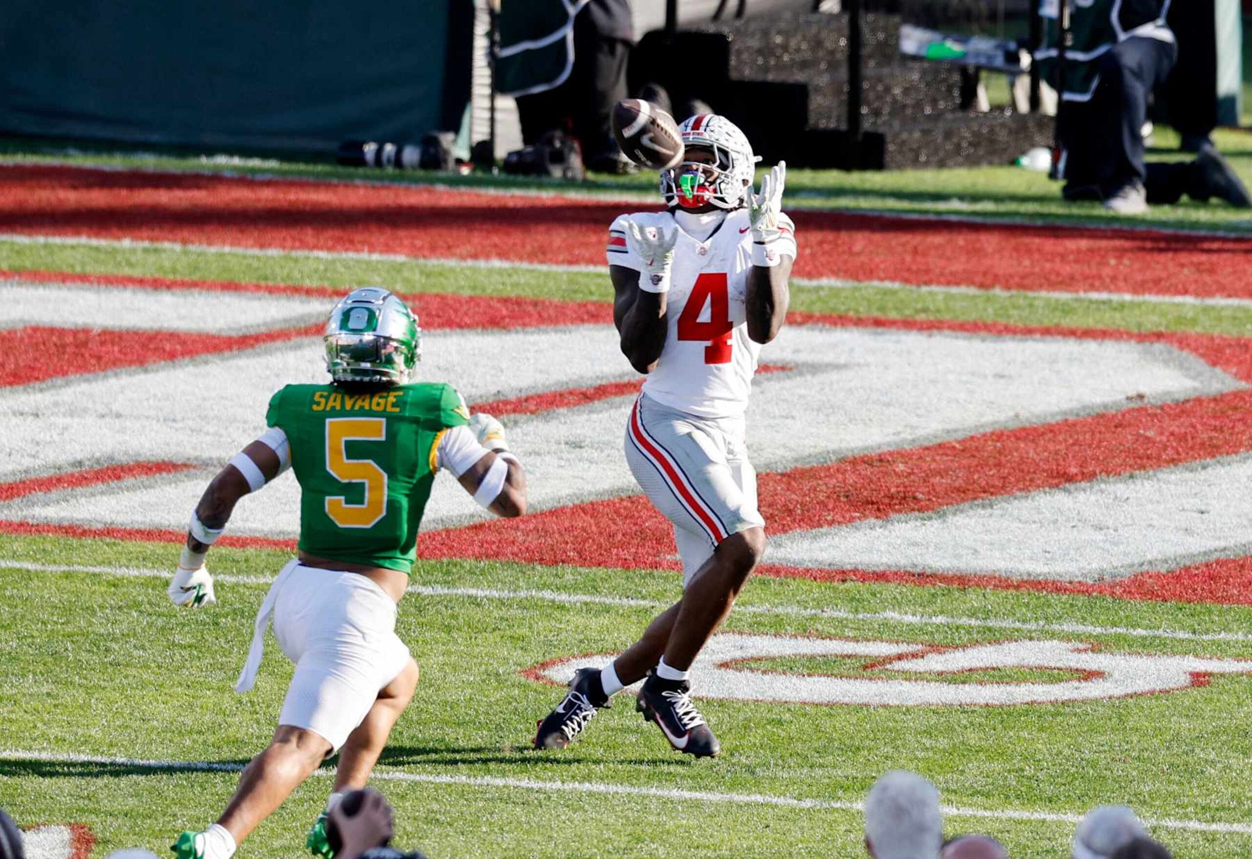 PASADENA, CALIFORNIA - JANUARY 1: Jeremiah Smith #4 of the Ohio State Buckeyes catches a pass and scores a touchdown against defensive back Kobe Savage #5 of the Oregon Ducks during the second quarter during the Rose Bowl Game Presented by Prudential at Rose Bowl Stadium on January 1, 2025 in Pasadena, California. (Photo by Kevork Djansezian/Getty Images) PASADENA, CALIFORNIA - JANUARY 1: Jeremiah Smith #4 of the Ohio State Buckeyes catches a pass and scores a touchdown against defensive back Kobe Savage #5 of the Oregon Ducks during the second quarter during the Rose Bowl Game Presented by Prudential at Rose Bowl Stadium on January 1, 2025 in Pasadena, California. (Photo by Kevork Djansezian/Getty Images)