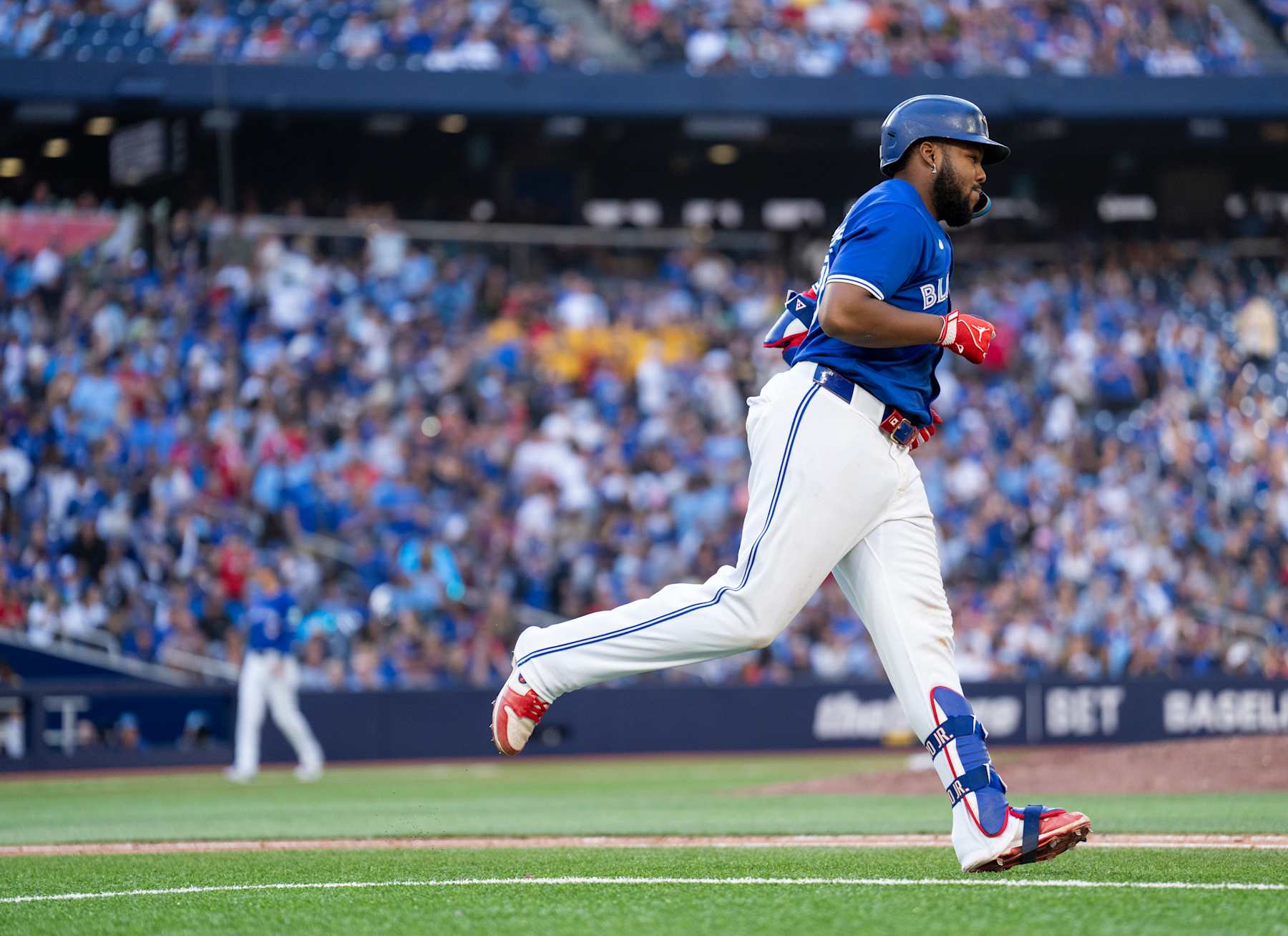 TORONTO, ON - SEPTEMBER 29: Vladimir Guerrero Jr. #27 of the Toronto Blue Jays jogs to first base after drawing a walk in his last at bat of the season against the Miami Marlins during the ninth inning in their MLB game at the Rogers Centre on September 29, 2024 in Toronto, Ontario, Canada. (Photo by Mark Blinch/Getty Images)