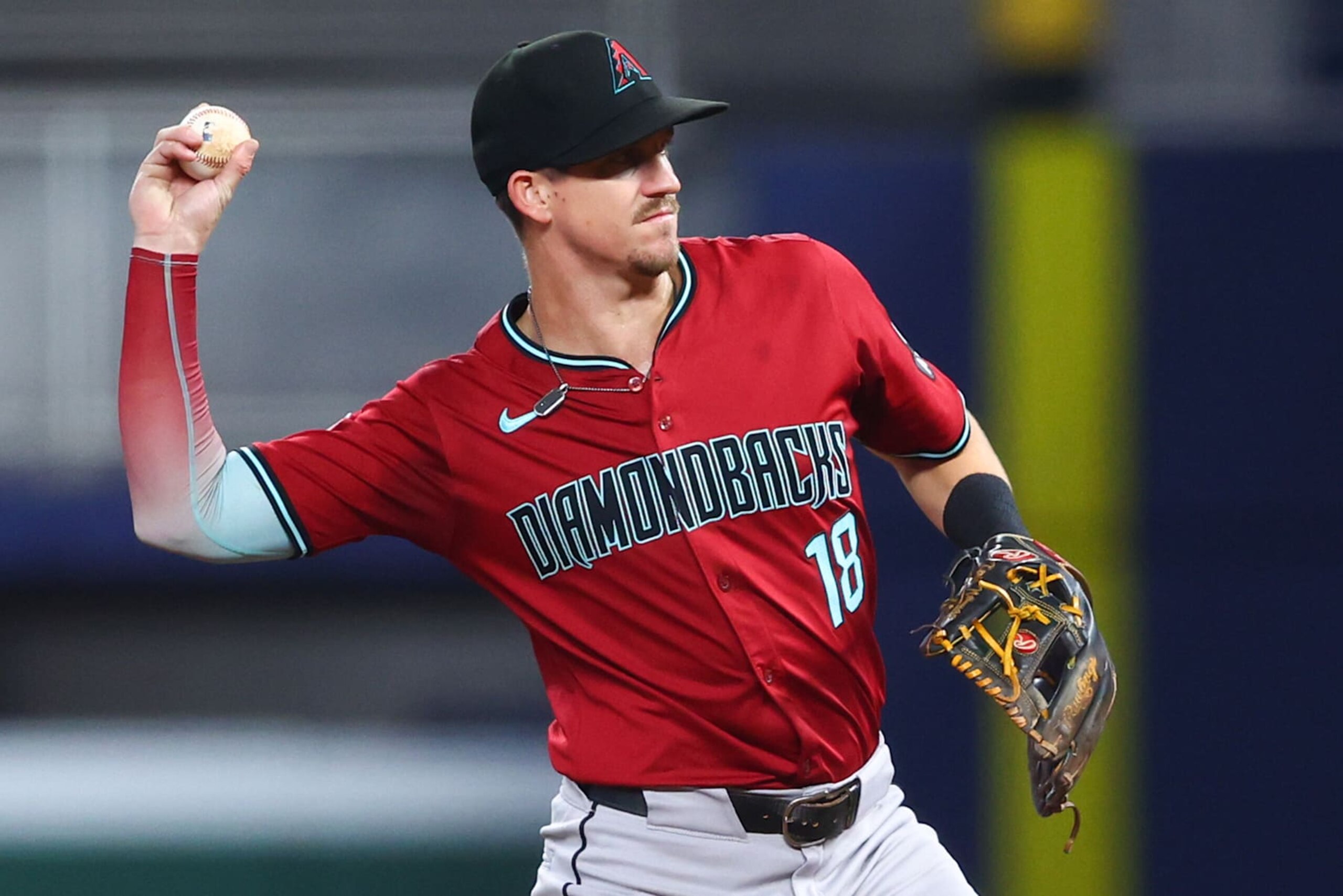 MIAMI, FLORIDA - AUGUST 20: Kevin Newman #18 of the Arizona Diamondbacks throws to first base for an out against the Miami Marlins during the second inning of the game at loanDepot park on August 20, 2024 in Miami, Florida. (Photo by Megan Briggs/Getty Images)