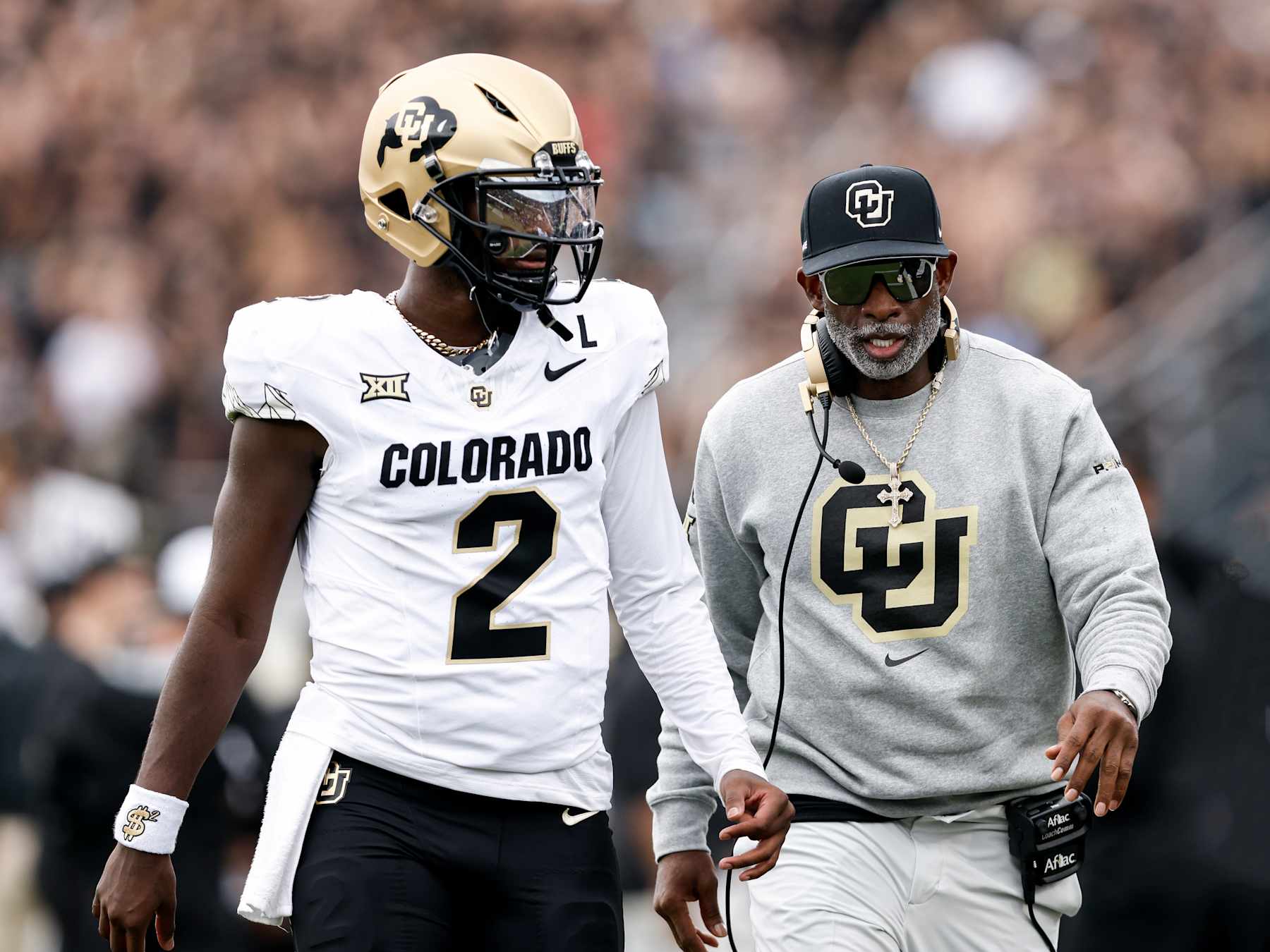 ORLANDO, FL - SEPTEMBER 28: Quarterback Shedeur Sanders #2 talk with Head Coach Deion Sanders of the Colorado Buffaloes prior to the game against the UCF Knights at FBC Mortgage Stadium on September 28, 2024 in Orlando, Florida. The Buffaloes defeated the Knights 48-21.(Photo by Don Juan Moore/Getty Images)