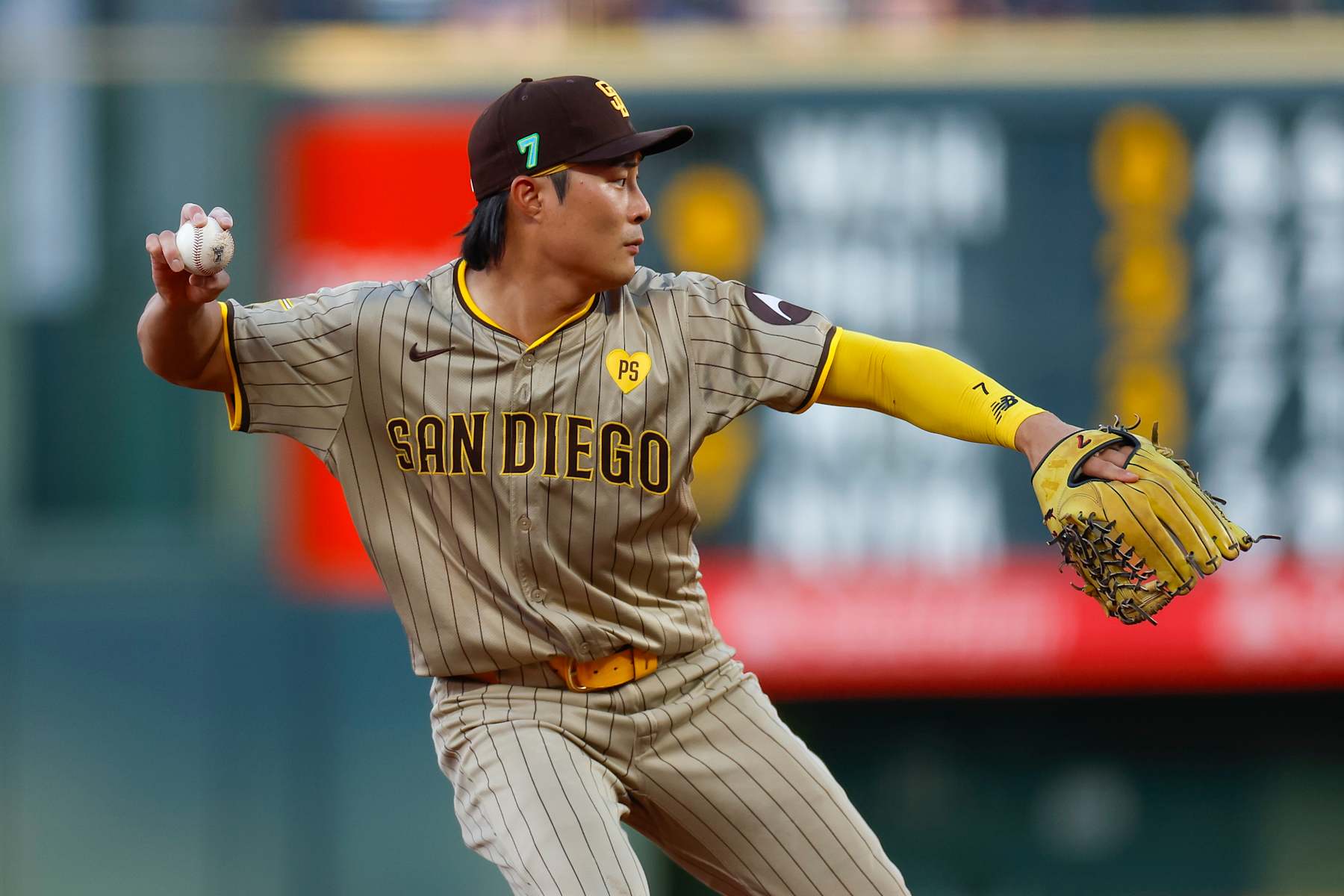 DENVER, COLORADO - AUGUST 16: Ha-Seong Kim #7 of the San Diego Padres throws to first base for an out in the second inning during a game against the Colorado Rockies at Coors Field on August 16, 2024 in Denver, Colorado. (Photo by Brandon Sloter/Image Of Sport/Getty Images)
