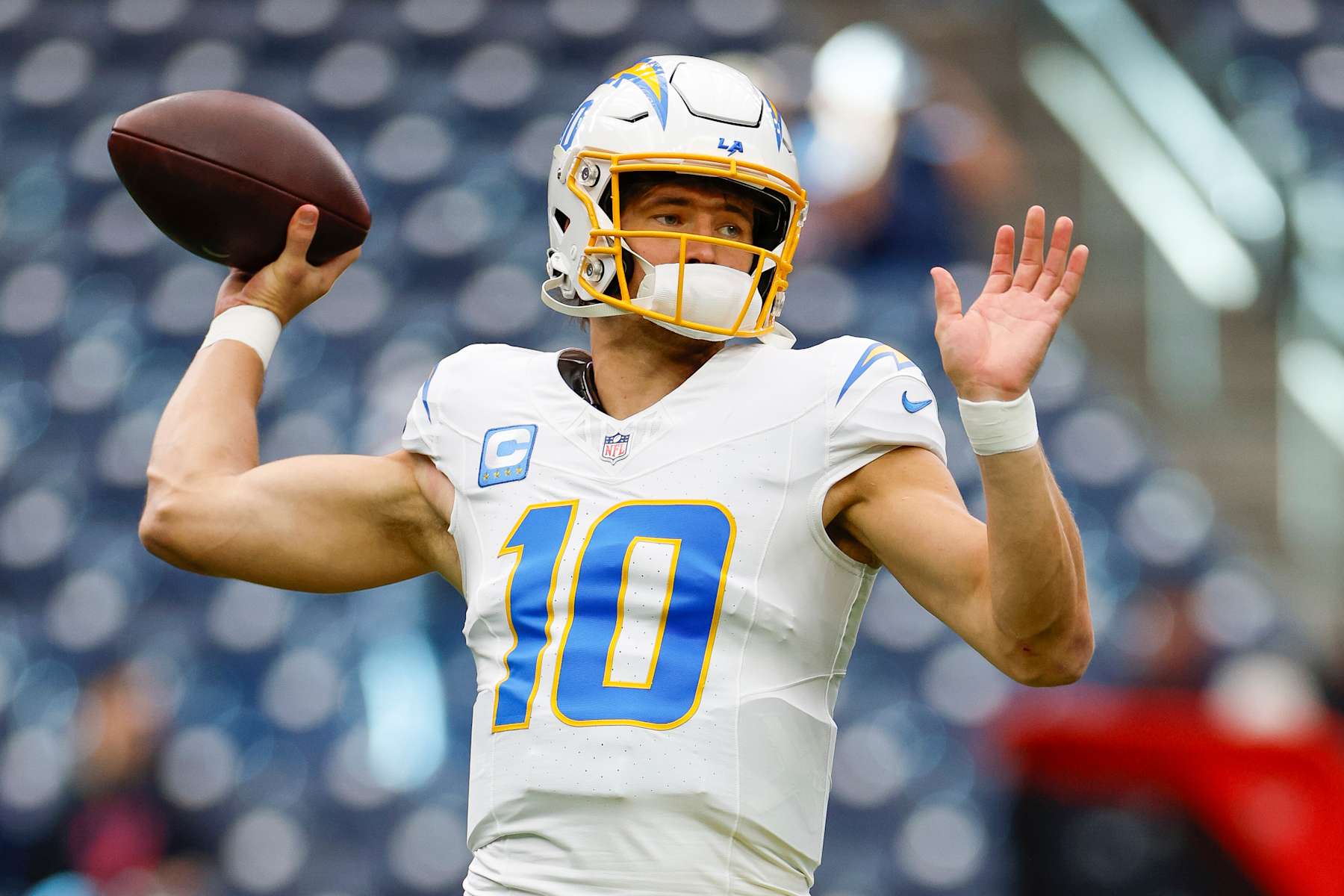 HOUSTON, TEXAS - JANUARY 11: Justin Herbert #10 of the Los Angeles Chargers warms up prior to the AFC Wild Card Playoff game against the Houston Texans at NRG Stadium on January 11, 2025 in Houston, Texas. (Photo by Brandon Sloter/Getty Images)
