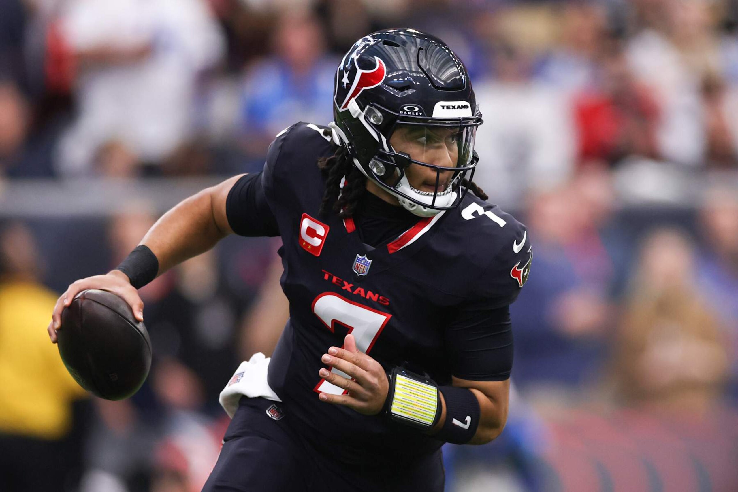 HOUSTON, TEXAS - JANUARY 11: C.J. Stroud #7 of the Houston Texans looks to pass against the Los Angeles Chargers in the first quarter during the AFC Wild Card Playoffs at NRG Stadium on January 11, 2025 in Houston, Texas. (Photo by Tim Warner/Getty Images)
