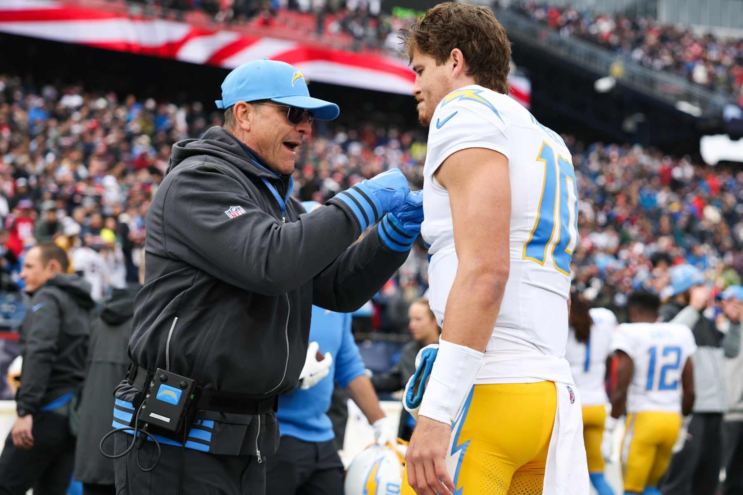 FOXBOROUGH, MASSACHUSETTS - DECEMBER 28: Jim Harbaugh head coach of the Los Angeles Chargers pumps up Justin Herbert #10 of the Los Angeles Chargers prior to the start of the game against the New England Patriots at Gillette Stadium on December 28, 2024 in Foxborough, Massachusetts. (Photo by Kathryn Riley/Getty Images) FOXBOROUGH, MASSACHUSETTS - DECEMBER 28: Jim Harbaugh head coach of the Los Angeles Chargers pumps up Justin Herbert #10 of the Los Angeles Chargers prior to the start of the game against the New England Patriots at Gillette Stadium on December 28, 2024 in Foxborough, Massachusetts. (Photo by Kathryn Riley/Getty Images)