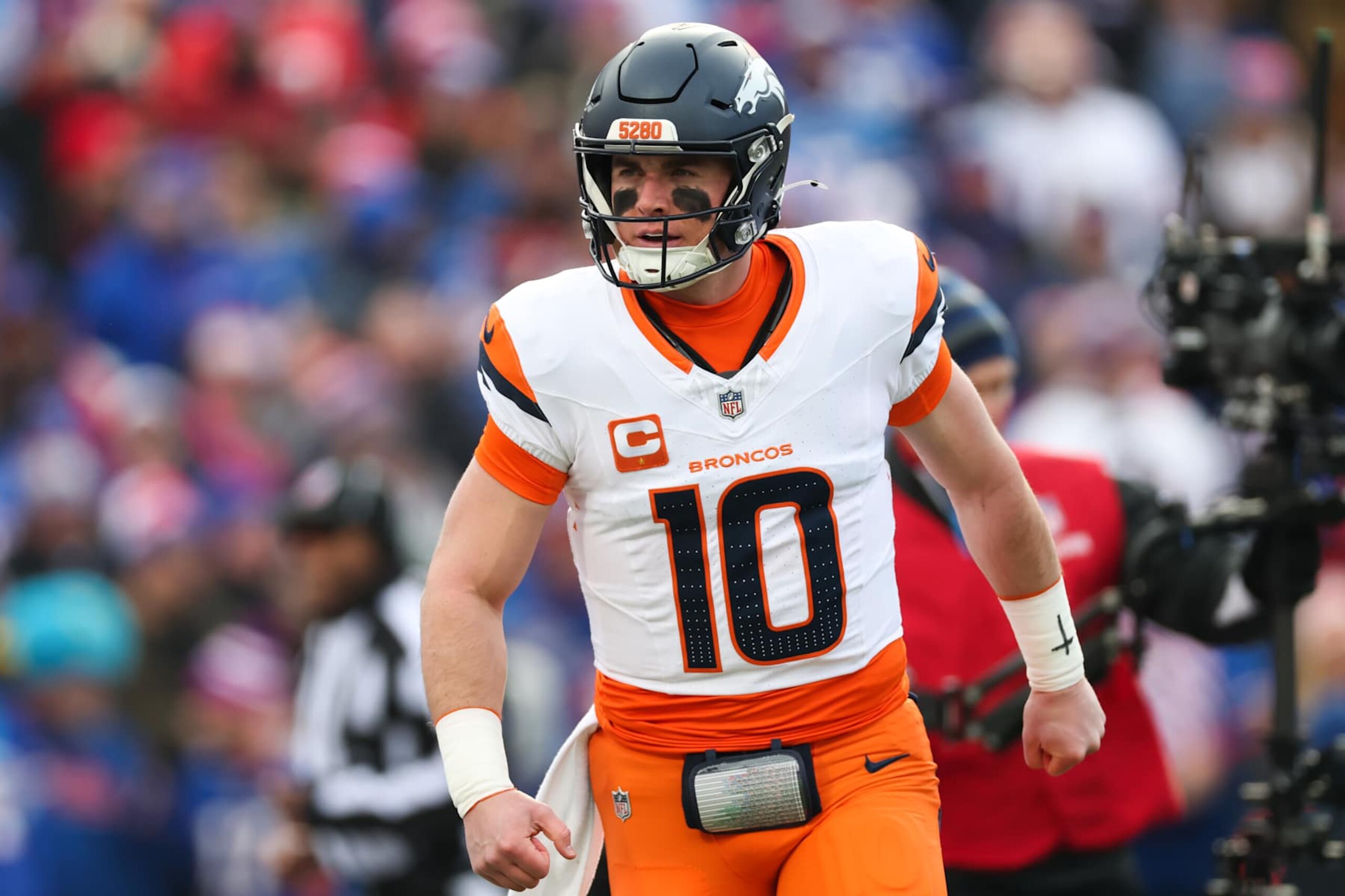 ORCHARD PARK, NEW YORK - JANUARY 12: Bo Nix #10 of the Denver Broncos celebrates after a touchdown against the Buffalo Bills during the first quarter during the AFC Wild Card Playoffs at Highmark Stadium on January 12, 2025 in Orchard Park, New York. (Photo by Elsa/Getty Images)