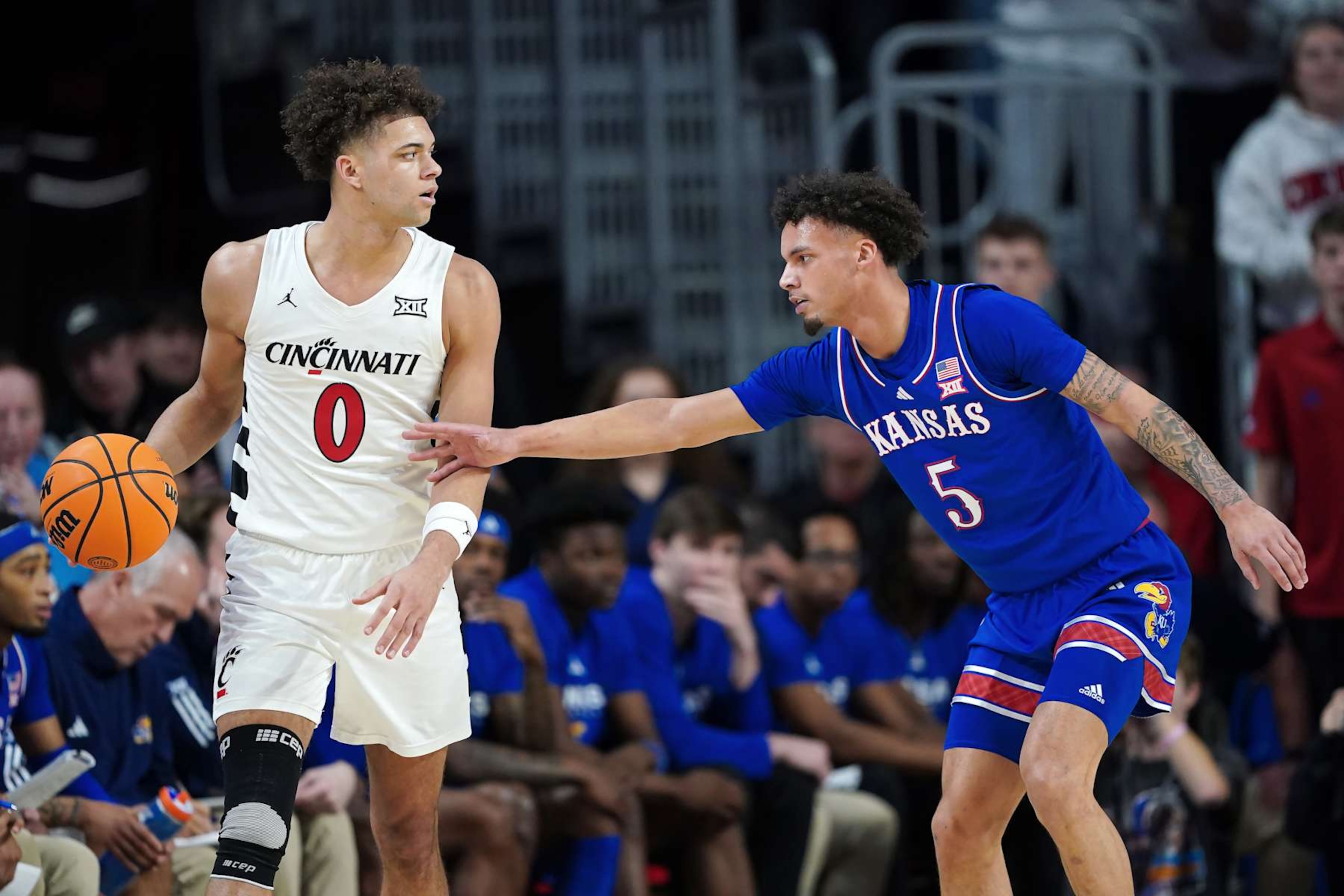 Kansas' Zeke Mayo defends Cincinnati's Dan Skillings Jr. Kansas' Zeke Mayo defends Cincinnati's Dan Skillings Jr.