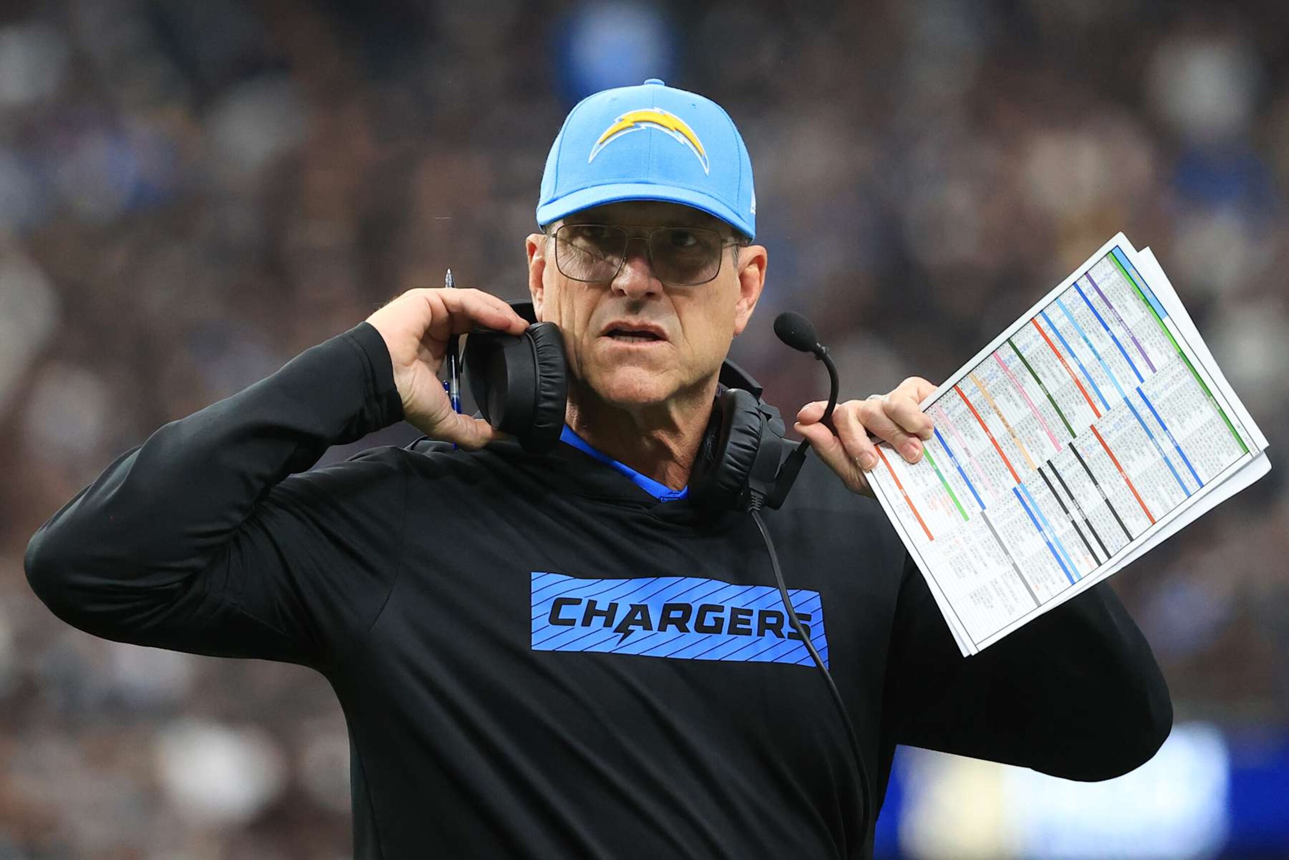 LAS VEGAS, NEVADA - JANUARY 05: Head coach Jim Harbaugh of the Los Angeles Chargers looks on during a timeout against the Las Vegas Raiders during the first quarter at Allegiant Stadium on January 05, 2025 in Las Vegas, Nevada. (Photo by Ian Maule/Getty Images) LAS VEGAS, NEVADA - JANUARY 05: Head coach Jim Harbaugh of the Los Angeles Chargers looks on during a timeout against the Las Vegas Raiders during the first quarter at Allegiant Stadium on January 05, 2025 in Las Vegas, Nevada. (Photo by Ian Maule/Getty Images)