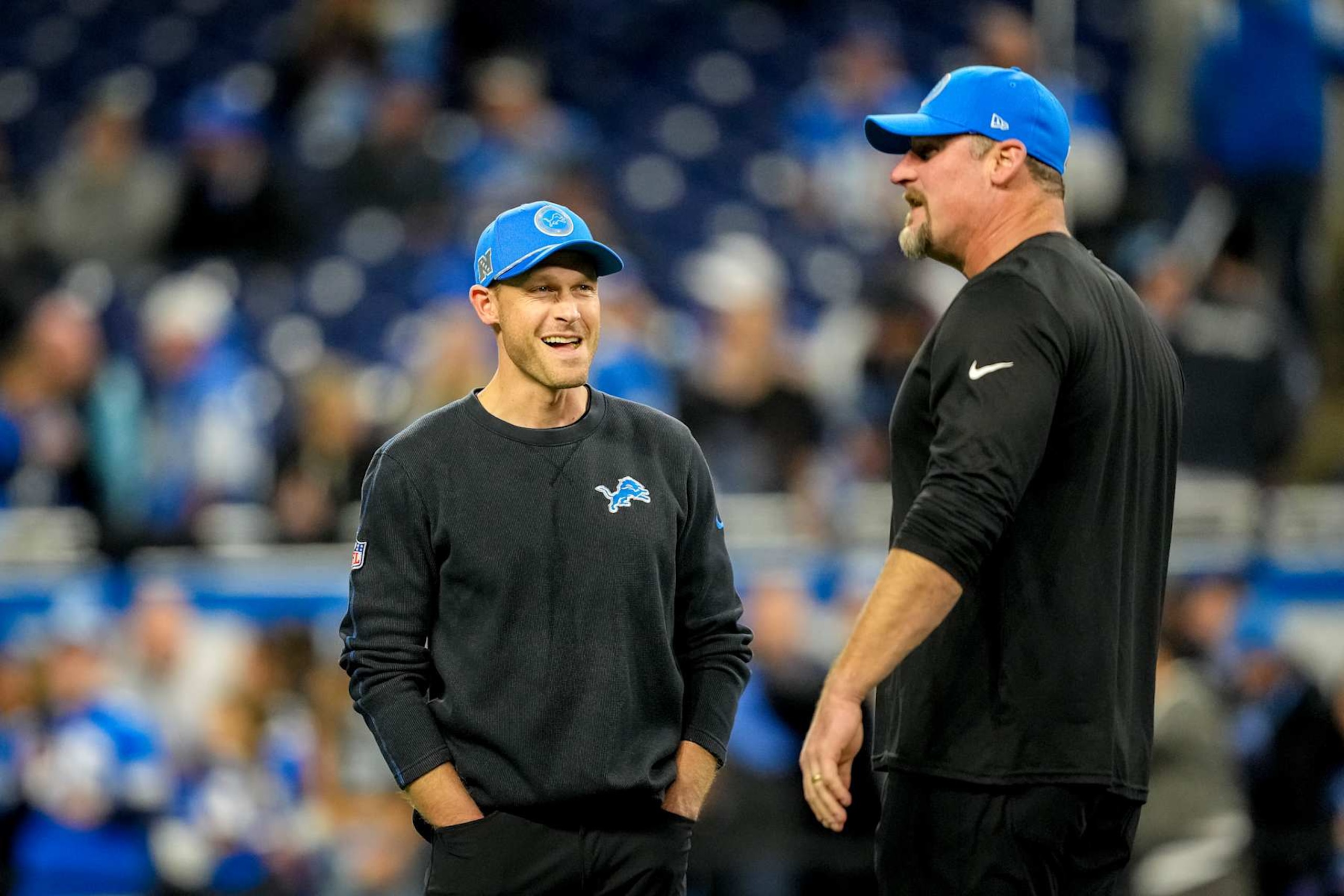 DETROIT, MICHIGAN - DECEMBER 05: Offensive coordinator Ben Johnson and head coach Dan Campbell of the Detroit Lions talk prior to a game against the Green Bay Packers at Ford Field on December 05, 2024 in Detroit, Michigan. (Photo by Nic Antaya/Getty Images) DETROIT, MICHIGAN - DECEMBER 05: Offensive coordinator Ben Johnson and head coach Dan Campbell of the Detroit Lions talk prior to a game against the Green Bay Packers at Ford Field on December 05, 2024 in Detroit, Michigan. (Photo by Nic Antaya/Getty Images)