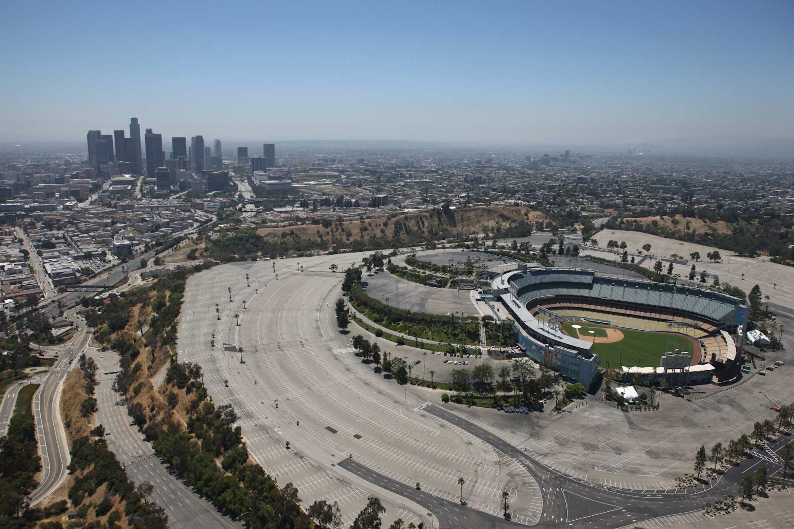 LOS ANGELES, CA - JULY 13: An aerial view of Dodger Stadium the home of the Los Angeles Dodgers with the city skyline in the background on July 13, 2010 in Los Angeles, California. (Photo by Tom Szczerbowski/Getty Images) LOS ANGELES, CA - JULY 13: An aerial view of Dodger Stadium the home of the Los Angeles Dodgers with the city skyline in the background on July 13, 2010 in Los Angeles, California. (Photo by Tom Szczerbowski/Getty Images)