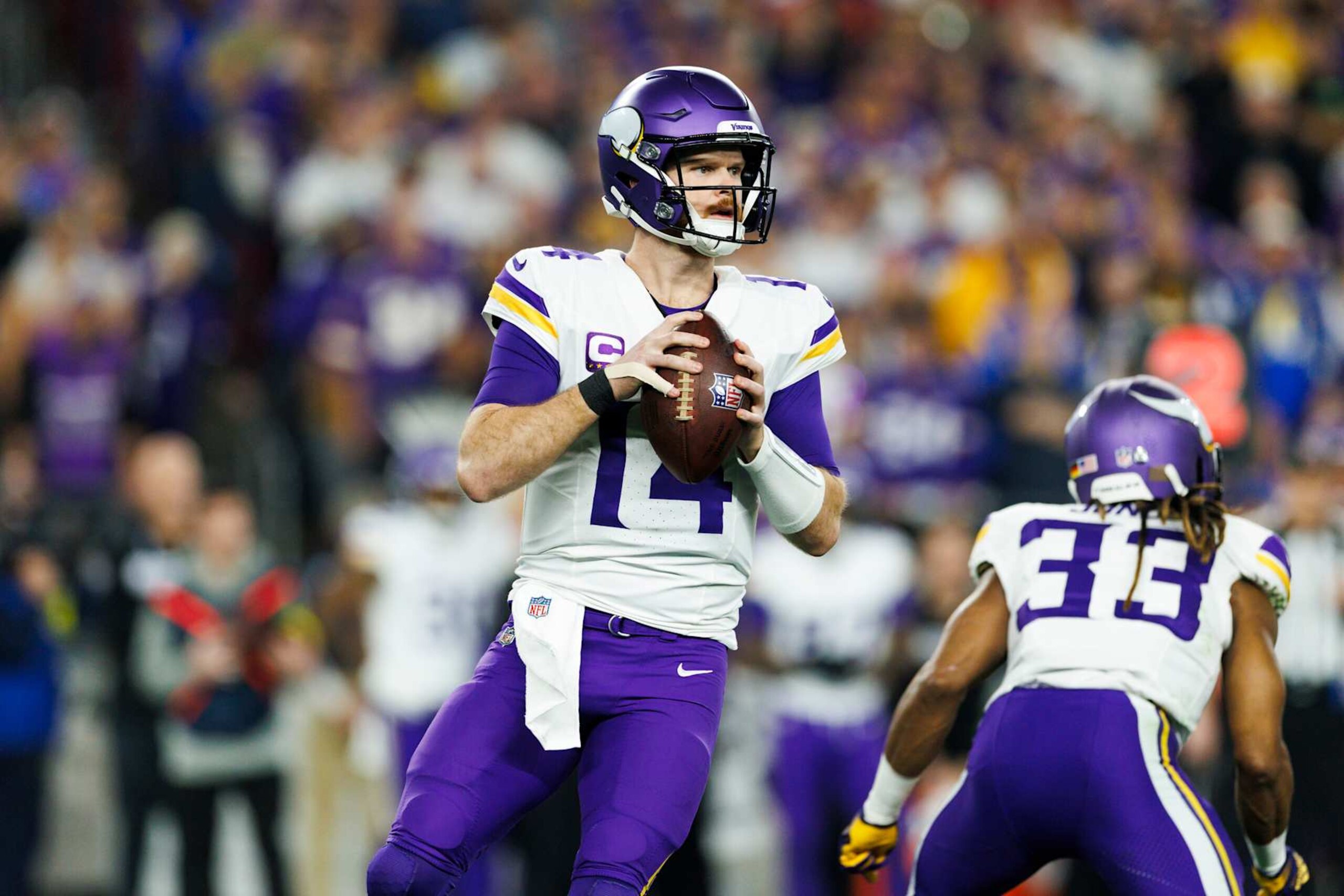 GLENDALE, ARIZONA - JANUARY 13: Sam Darnold #14 of the Minnesota Vikings drops back to pass during the first half of the NFC Wild Card Playoff game against the Los Angeles Rams at State Farm Stadium on January 13, 2025 in Glendale, Arizona. (Photo by Ric Tapia/Getty Images) GLENDALE, ARIZONA - JANUARY 13: Sam Darnold #14 of the Minnesota Vikings drops back to pass during the first half of the NFC Wild Card Playoff game against the Los Angeles Rams at State Farm Stadium on January 13, 2025 in Glendale, Arizona. (Photo by Ric Tapia/Getty Images)