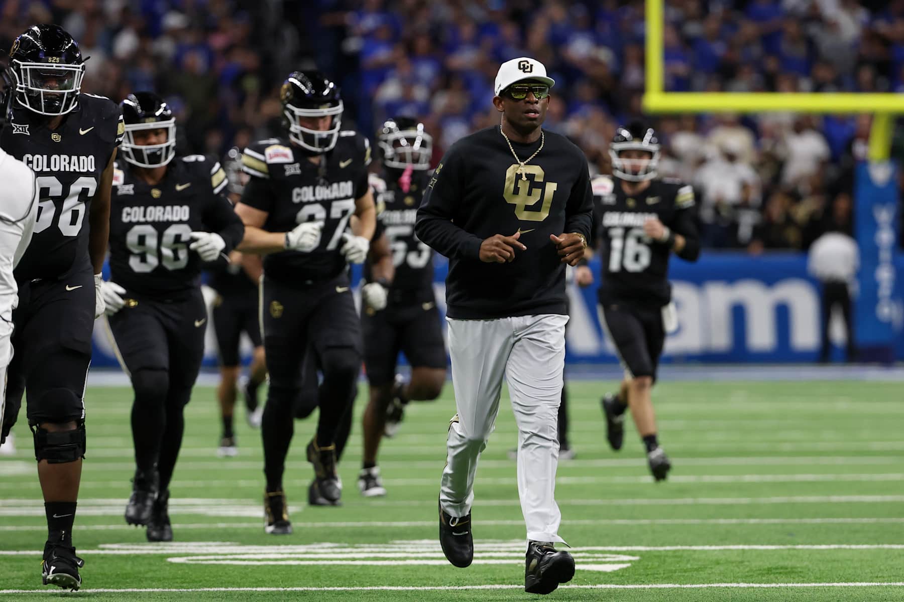 SAN ANTONIO, TX - DECEMBER 28: Colorado Buffaloes head coach Deion Sanders leads his players onto the field before the football game between BYU Cougars and Colorado Buffalos on December 28, 2024, at the Alamodome in San Antonio, Texas. (Photo by David Buono/Icon Sportswire via Getty Images)