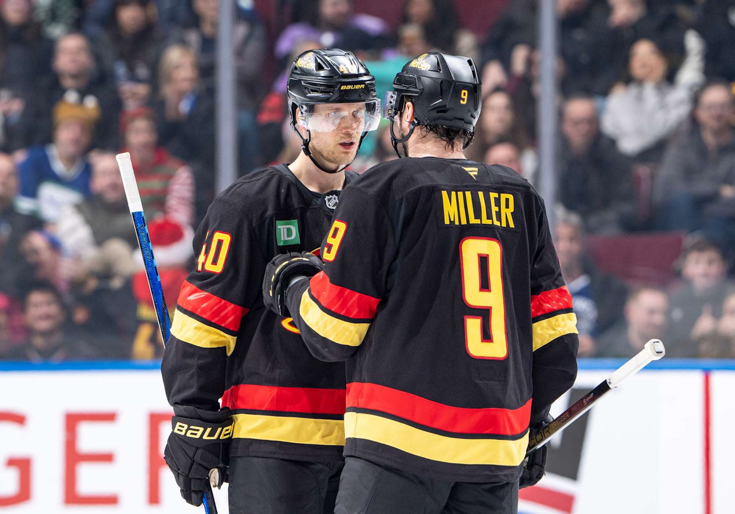 VANCOUVER, CANADA - DECEMBER 23: Elias Pettersson #40 and J.T. Miller #9 of the Vancouver Canucks discuss game play during the second period of their NHL game against the San Jose Sharks at Rogers Arena on December 23, 2024 in Vancouver, British Columbia, Canada.  (Photo by Jeff Vinnick/NHLI via Getty Images)
