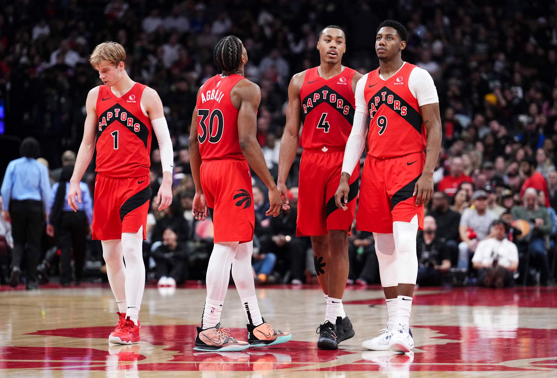 TORONTO, ON - DECEMBER 29: Gradey Dick #1, Ochai Agbaji #30, Scottie Barnes #4 and RJ Barrett #9 of the Toronto Raptors look on in a break in play against the Atlanta Hawks during the first half of their basketball game at the Scotiabank Arena on December 29, 2024 in Toronto, Ontario, Canada. NOTE TO USER: User expressly acknowledges and agrees that, by downloading and/or using this Photograph, user is consenting to the terms and conditions of the Getty Images License Agreement. (Photo by Mark Blinch/Getty Images)