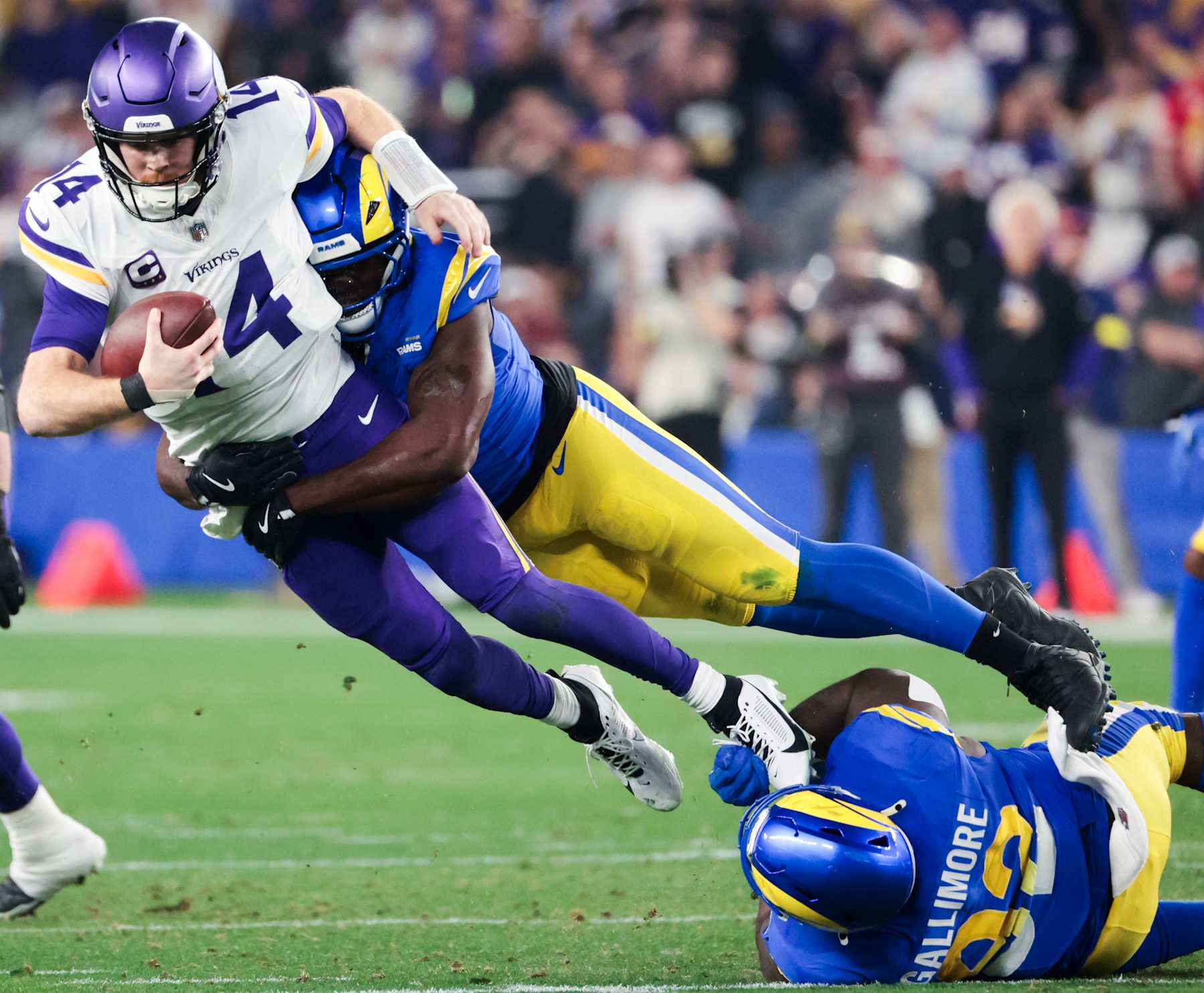 GLENDALE, AZ - JANUARY 13: Los Angeles Rams linebacker Byron Young, back, tackles Minnesota Vikings quarterback Sam Darnold during the second quarter of the NFC Wildcard game at State Farm Stadium on Monday, Jan. 13, 2025 in Glendale, AZ. (Wally Skalij / Los Angeles Times via Getty Images)