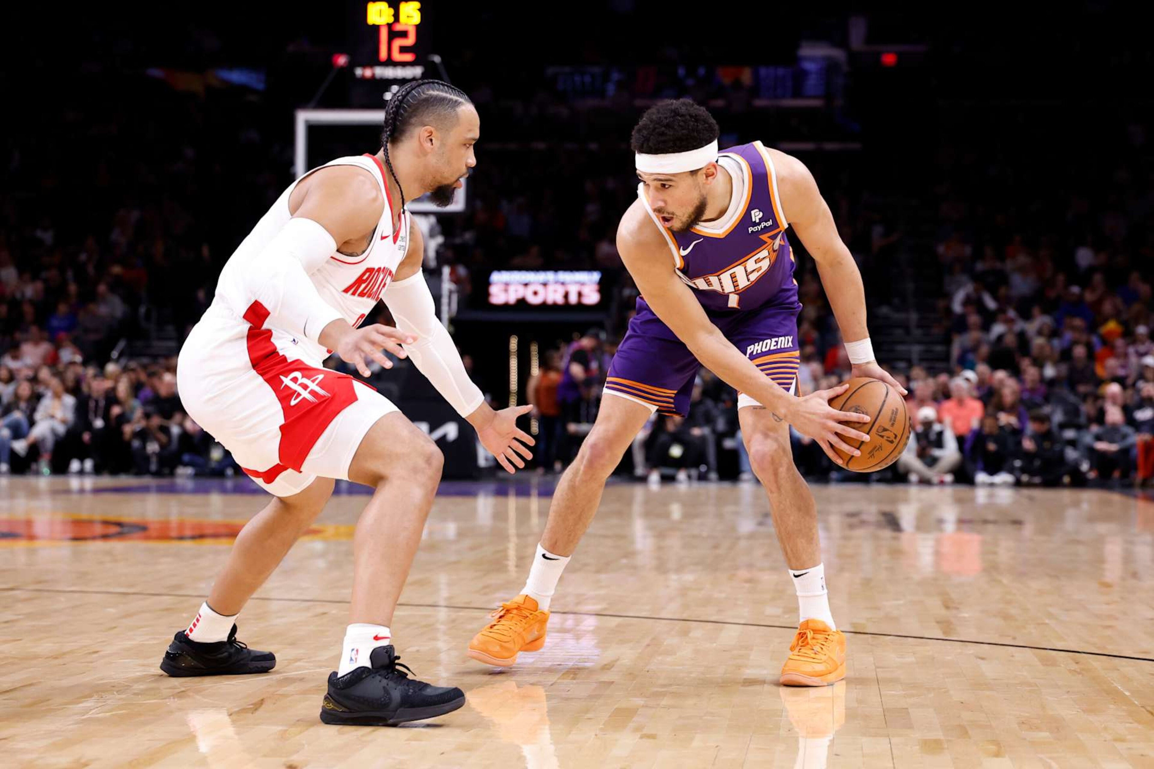 PHOENIX, ARIZONA - MARCH 02: Devin Booker #1 of the Phoenix Suns posts up on Dillon Brooks #9 of the Houston Rockets during the game at Footprint Center on March 02, 2024 in Phoenix, Arizona. The Rockets defeated the Suns 118-109. NOTE TO USER: User expressly acknowledges and agrees that, by downloading and or using this photograph, User is consenting to the terms and conditions of the Getty Images License Agreement. (Photo by Chris Coduto/Getty Images) PHOENIX, ARIZONA - MARCH 02: Devin Booker #1 of the Phoenix Suns posts up on Dillon Brooks #9 of the Houston Rockets during the game at Footprint Center on March 02, 2024 in Phoenix, Arizona. The Rockets defeated the Suns 118-109. NOTE TO USER: User expressly acknowledges and agrees that, by downloading and or using this photograph, User is consenting to the terms and conditions of the Getty Images License Agreement. (Photo by Chris Coduto/Getty Images)
