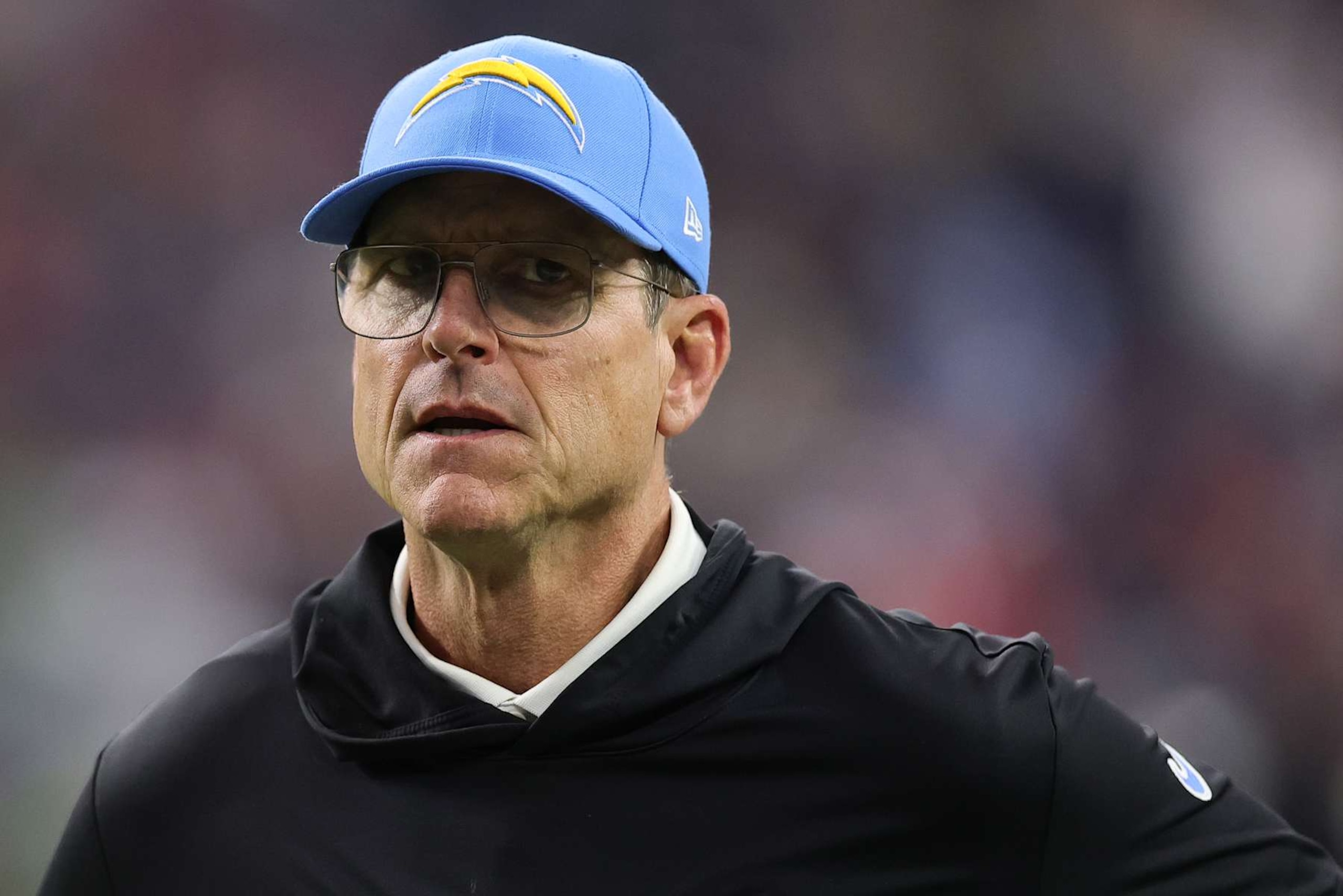 HOUSTON, TEXAS - JANUARY 11: Head coach Jim Harbaugh of the Los Angeles Chargers looks on at halftime against the Houston Texans during the AFC Wild Card Playoffs at NRG Stadium on January 11, 2025 in Houston, Texas. (Photo by Alex Slitz/Getty Images) HOUSTON, TEXAS - JANUARY 11: Head coach Jim Harbaugh of the Los Angeles Chargers looks on at halftime against the Houston Texans during the AFC Wild Card Playoffs at NRG Stadium on January 11, 2025 in Houston, Texas. (Photo by Alex Slitz/Getty Images)