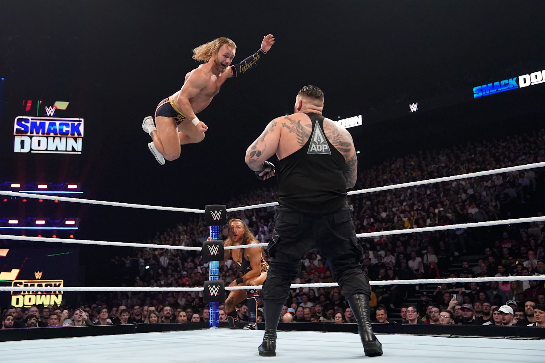 LYON, FRANCE - MAY 03: Tyler Bate of the New Catch Republic performs a flying shoulder dive against Rezar of the AOP as Bate's tag mate Pete Donne looks on during SmackDown at LDLC Arena on May 3, 2024 in Lyon, France.  (Photo by WWE/Getty Images)