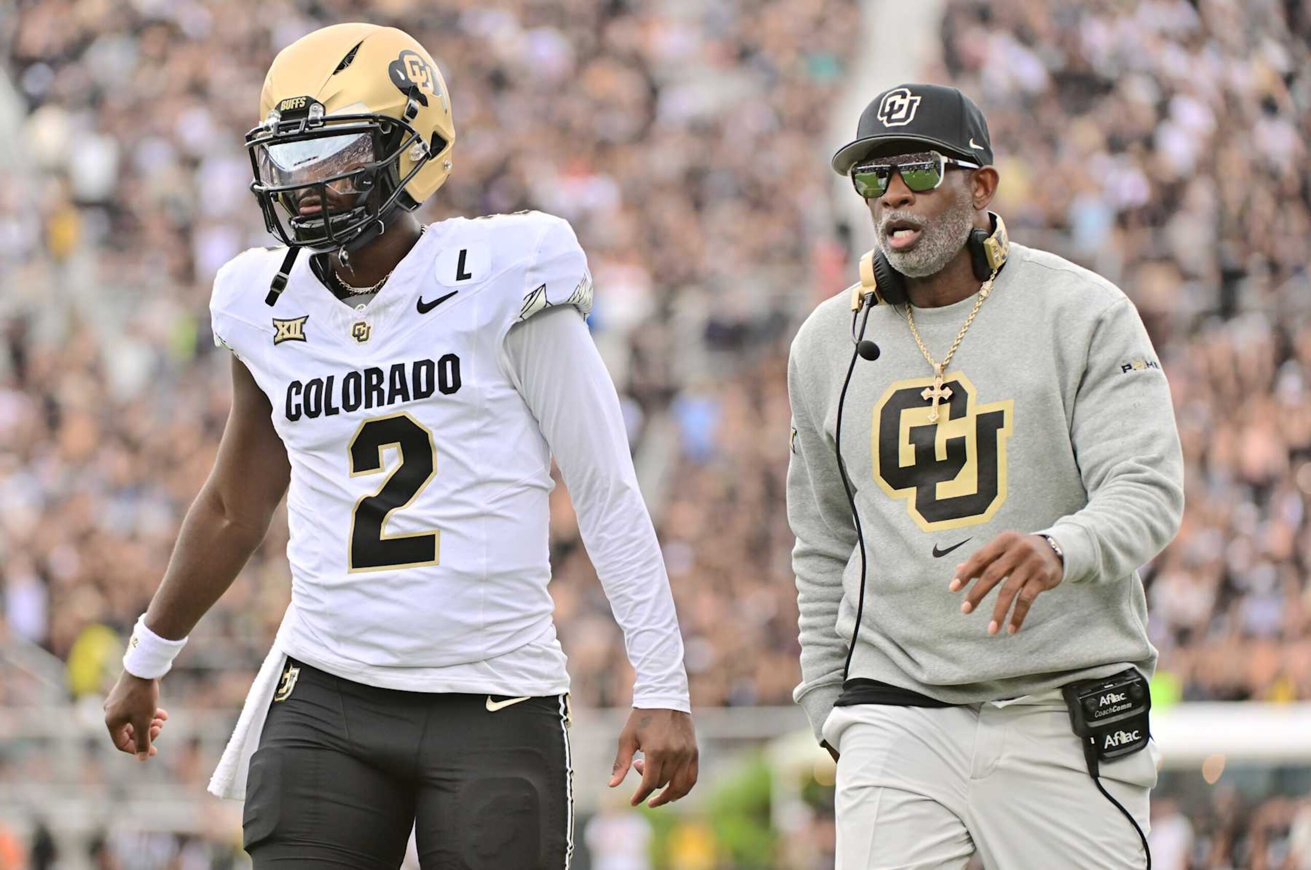 ORLANDO, FLORIDA - SEPTEMBER 28: Head coach Deion Sanders of the Colorado Buffaloes talks with Shedeur Sanders #2 prior to a game against the UCF Knights at FBC Mortgage Stadium on September 28, 2024 in Orlando, Florida. (Photo by Julio Aguilar/Getty Images) ORLANDO, FLORIDA - SEPTEMBER 28: Head coach Deion Sanders of the Colorado Buffaloes talks with Shedeur Sanders #2 prior to a game against the UCF Knights at FBC Mortgage Stadium on September 28, 2024 in Orlando, Florida. (Photo by Julio Aguilar/Getty Images)