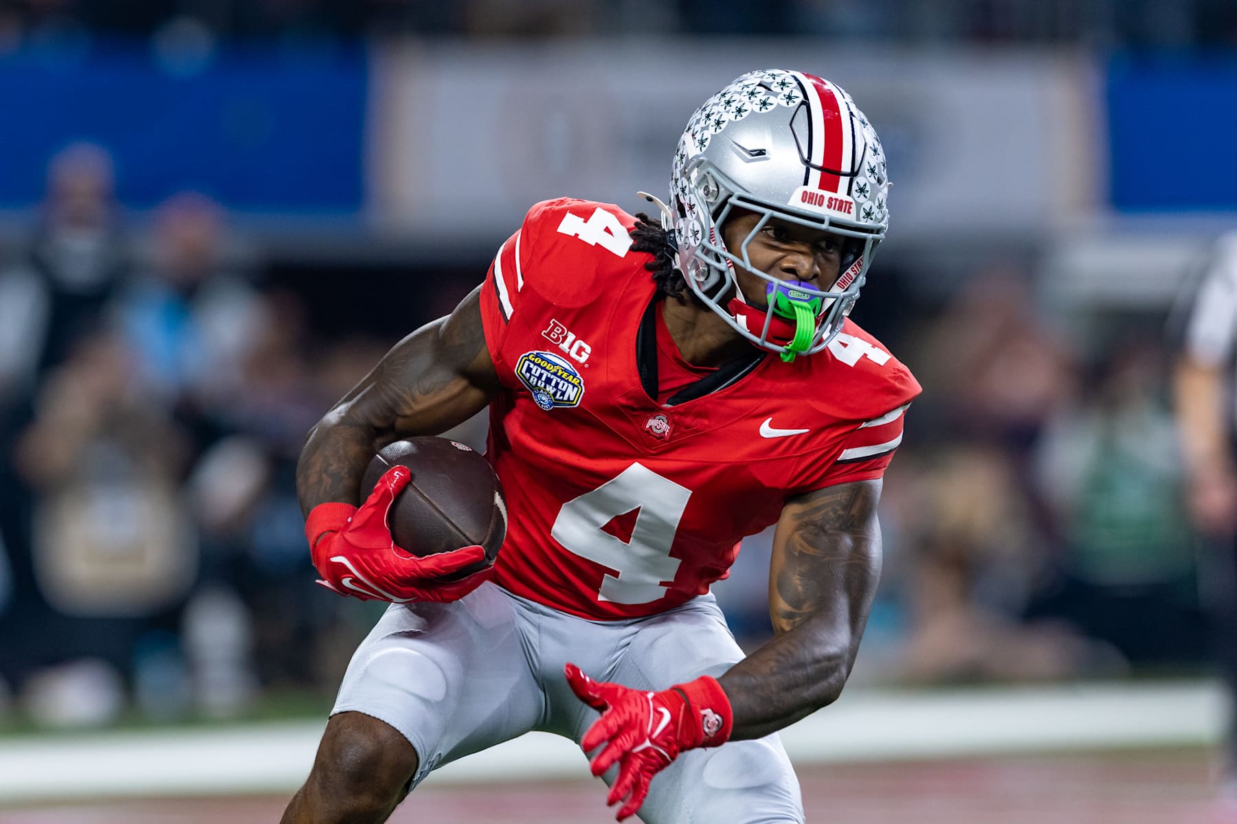 ARLINGTON, TX - JANUARY 10: Ohio State Buckeyes wide receiver Jeremiah Smith (#4) runs up field after making a catch during the CFP Semifinal Cotton Bowl Classic football game between the Ohio State Buckeyes and Texas Longhorns on January 10, 2025 at AT&T Stadium in Arlington, TX.  (Photo by Matthew Visinsky/Icon Sportswire via Getty Images)