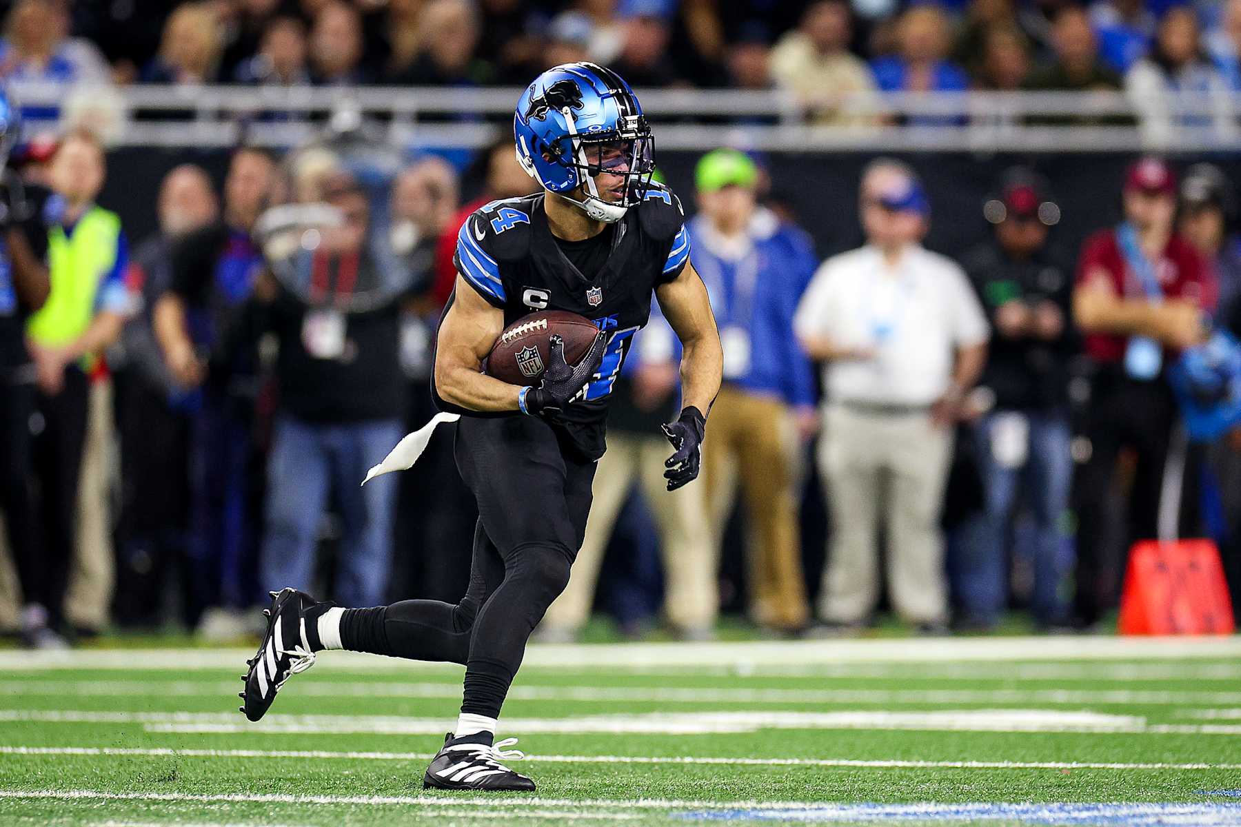 DETROIT, MICHIGAN - JANUARY 05: Amon-Ra St. Brown #14 of the Detroit Lions runs the ball up the field in the first quarter of a game against the Minnesota Vikings at Ford Field on January 05, 2025 in Detroit, Michigan. (Photo by Mike Mulholland/Getty Images)
