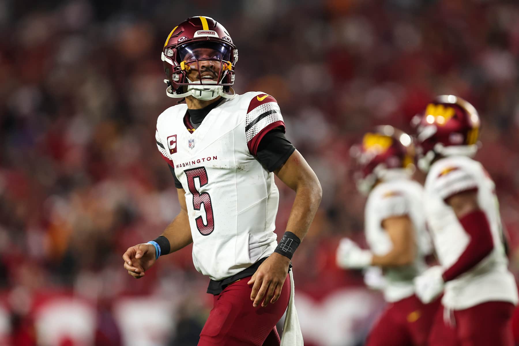 TAMPA, FLORIDA - JANUARY 12: Jayden Daniels #5 of the Washington Commanders looks on from the field during an NFL football wild card playoff game against the Tampa Bay Buccaneers at Raymond James Stadium on January 12, 2025 in Tampa, Florida. (Photo by Perry Knotts/Getty Images)