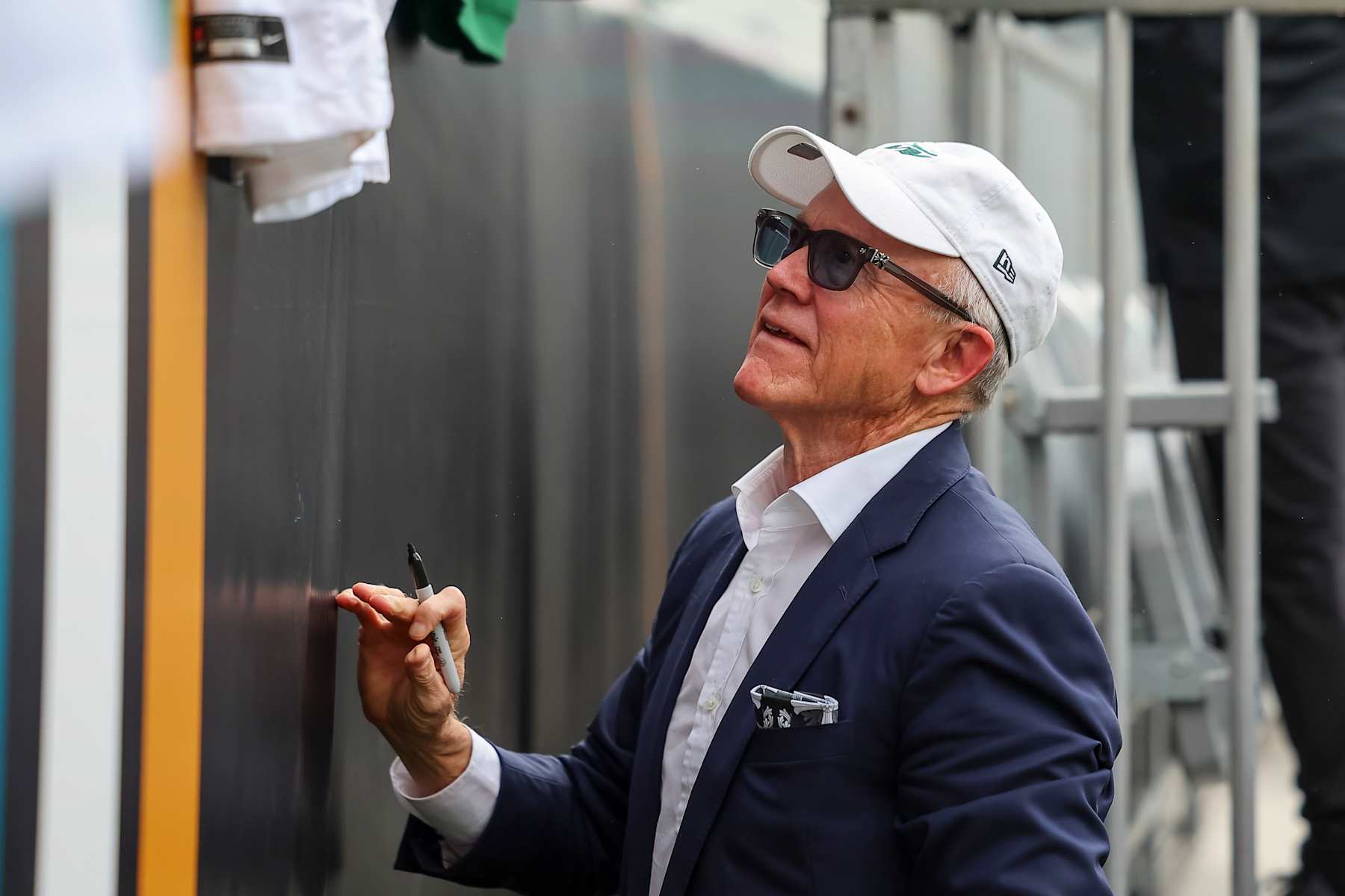JACKSONVILLE, FLORIDA - DECEMBER 15: Owner Woody Johnson of the New York Jets signs for fans prior to the game against the Jacksonville Jaguars at EverBank Field on December 15, 2024 in Jacksonville, Florida. (Photo by Mike Carlson/Getty Images)