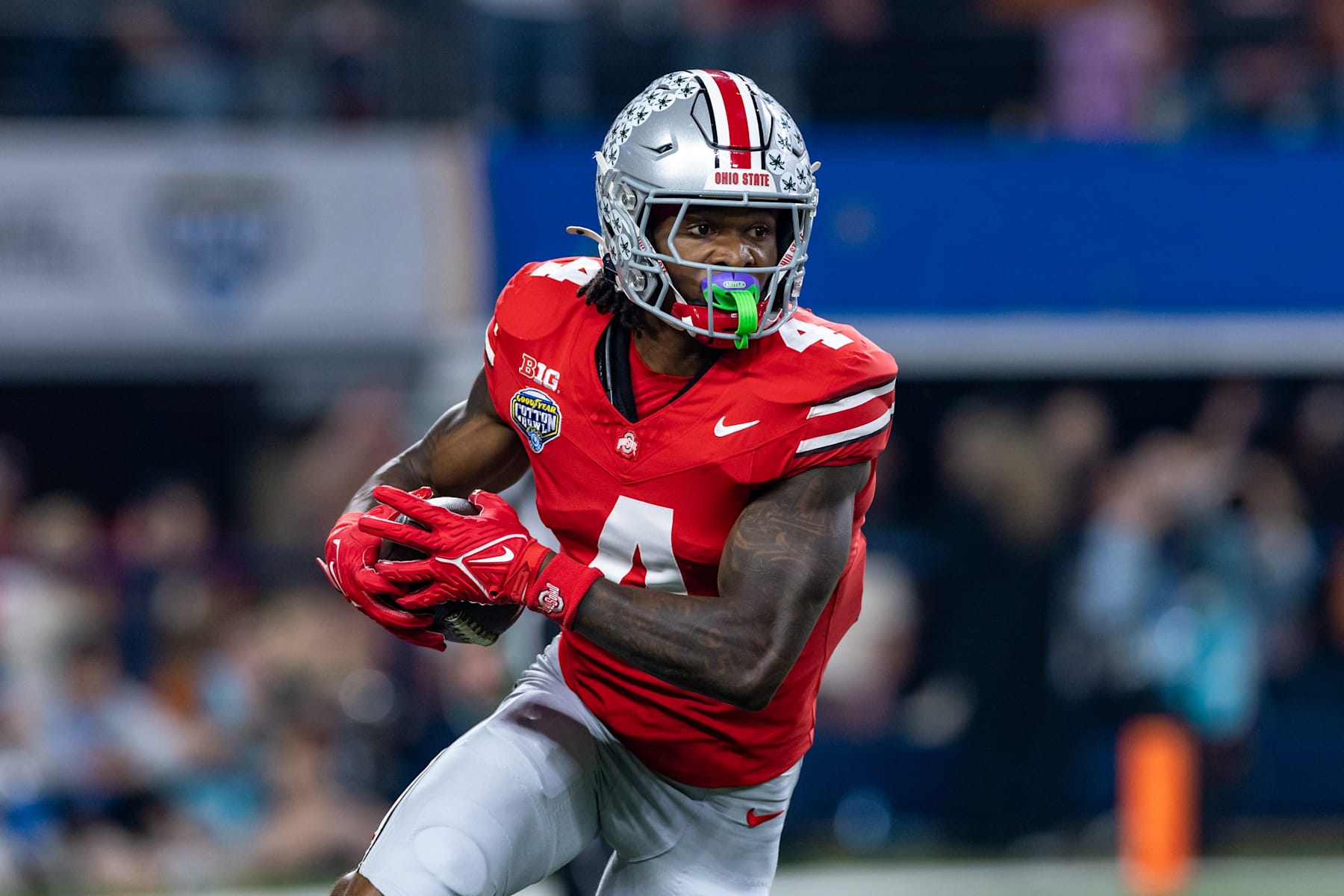 ARLINGTON, TX - JANUARY 10: Ohio State Buckeyes wide receiver Jeremiah Smith (#4) runs up field after making a catch during the CFP Semifinal Cotton Bowl Classic football game between the Ohio State Buckeyes and Texas Longhorns on January 10, 2025 at AT&T Stadium in Arlington, TX.  (Photo by Matthew Visinsky/Icon Sportswire via Getty Images)