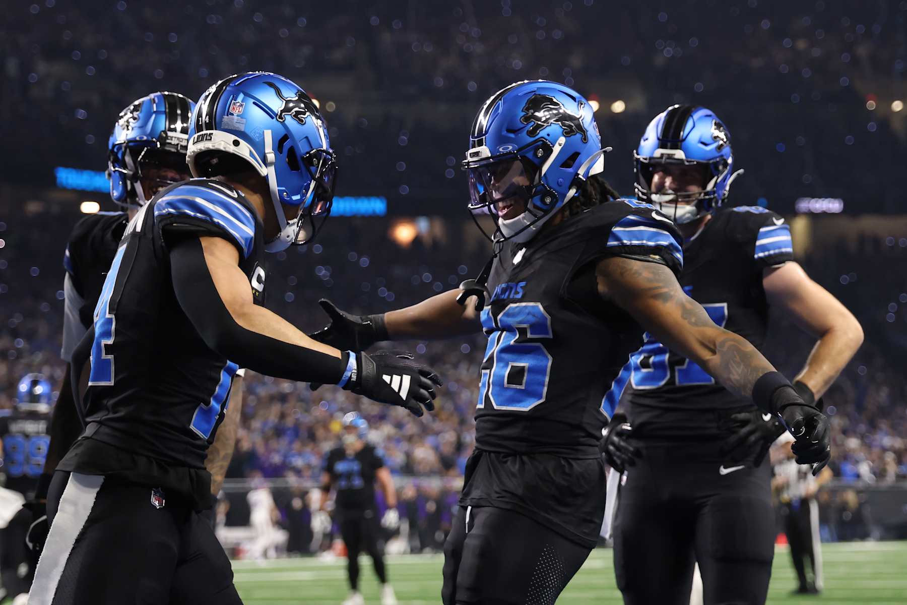 DETROIT, MICHIGAN - JANUARY 05: Jahmyr Gibbs #26 of the Detroit Lions celebrates a touchdown with Amon-Ra St. Brown #14 during the first quarter against the Minnesota Vikings at Ford Field on January 05, 2025 in Detroit, Michigan. (Photo by Gregory Shamus/Getty Images)