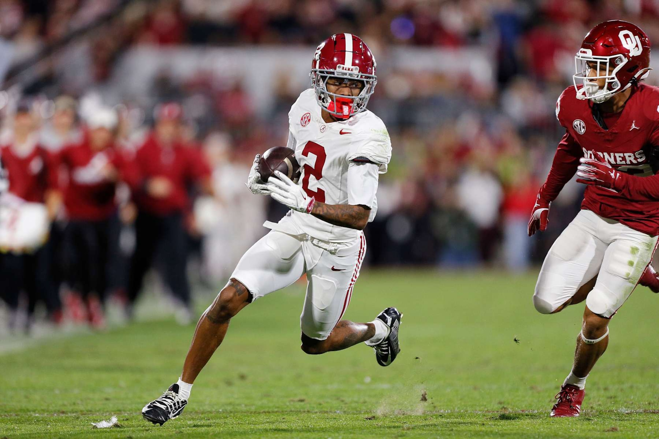NORMAN, OKLAHOMA - NOVEMBER 23: Wide receiver Ryan Williams #2 of the Alabama Crimson Tide runs with a 19-yard catch for a 30-yard gain against cornerback Eli Bowen #23 of the Oklahoma Sooners in the first quarter at Gaylord Family Oklahoma Memorial Stadium on November 23, 2024 in Norman, Oklahoma. Oklahoma won 24-3. (Photo by Brian Bahr/Getty Images)