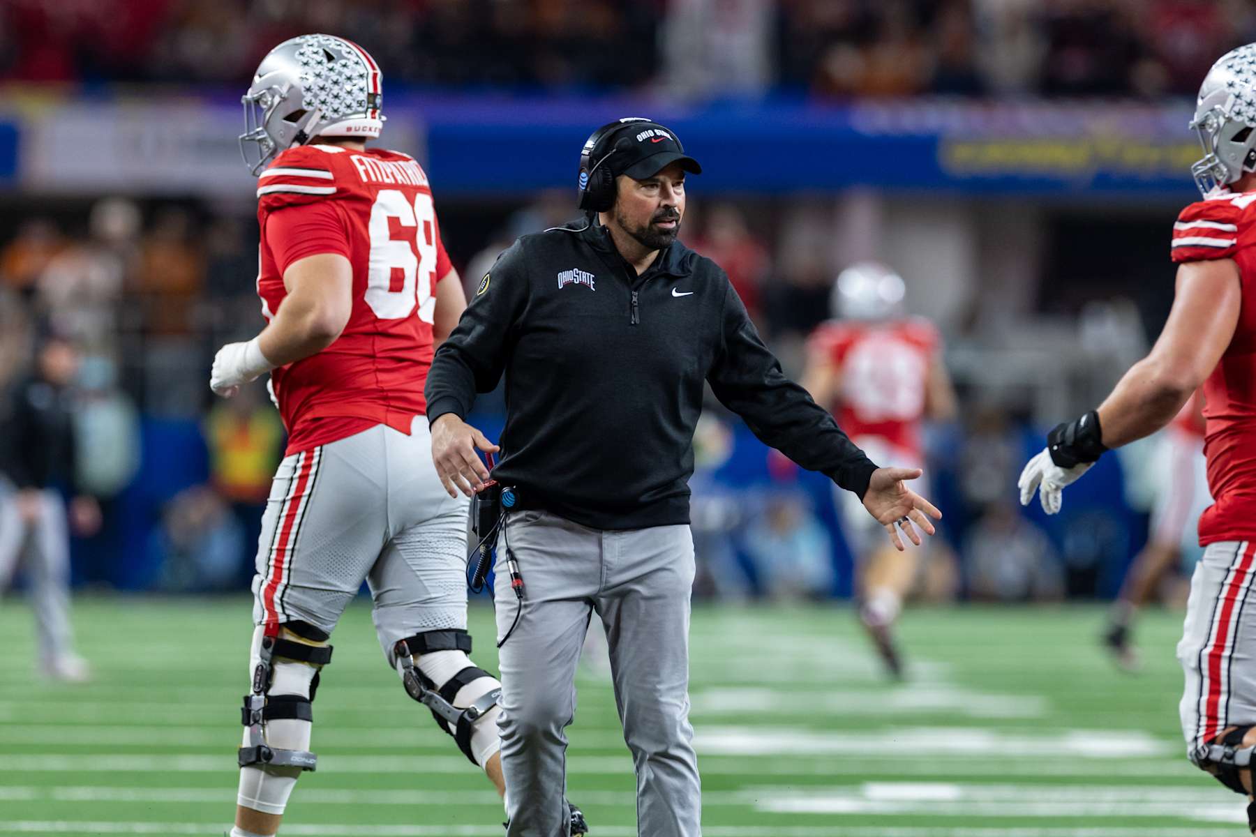 ARLINGTON, TX - JANUARY 10: Ohio State Buckeyes head coach Ryan Day high fives players as they come off the field during the CFP Semifinal Cotton Bowl Classic football game between the Ohio State Buckeyes and Texas Longhorns on January 10, 2025 at AT&T Stadium in Arlington, TX.  (Photo by Matthew Visinsky/Icon Sportswire via Getty Images)