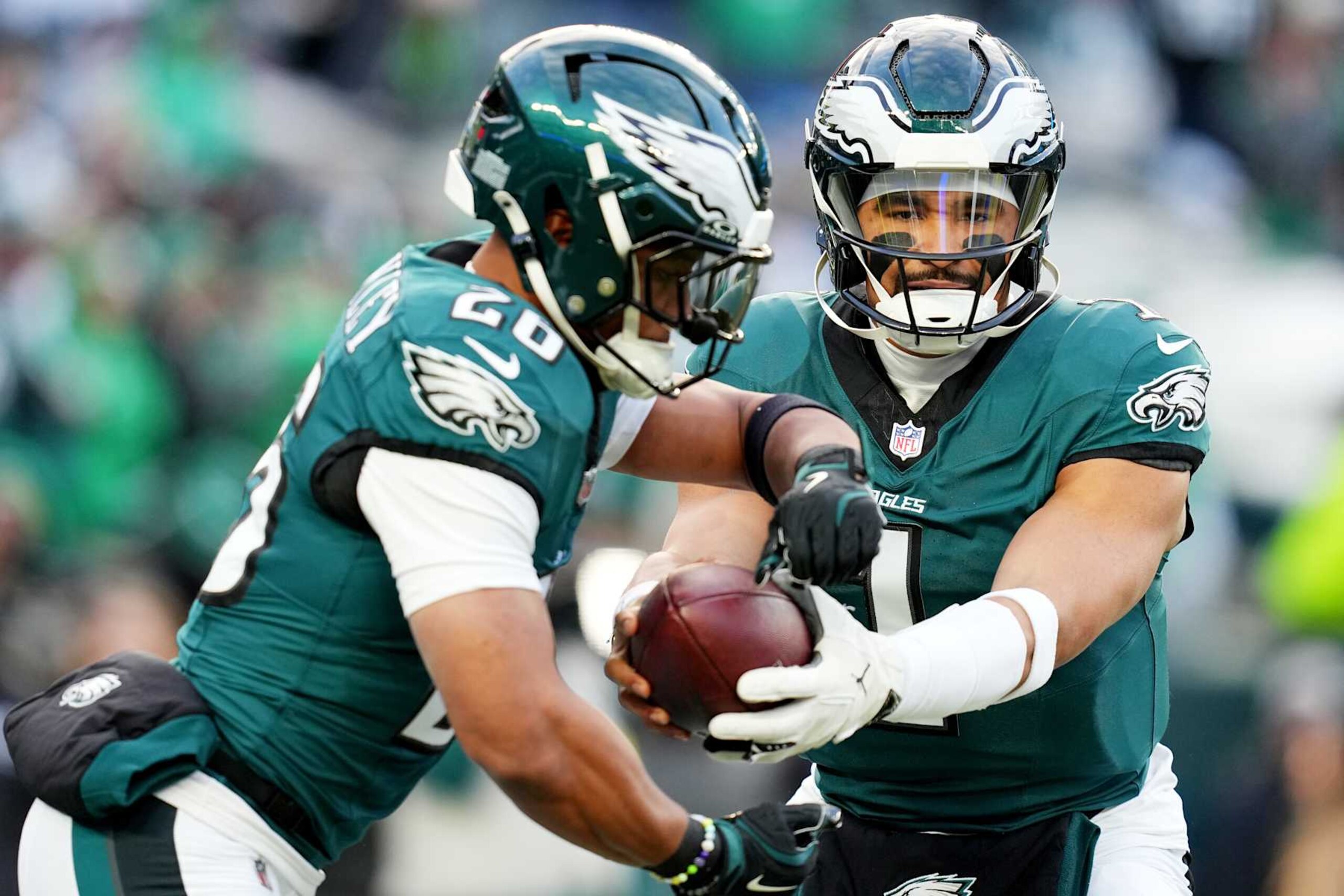 PHILADELPHIA, PENNSYLVANIA - JANUARY 12: Jalen Hurts #1 hands off to Saquon Barkley #26 of the Philadelphia Eagles prior to a game against the Green Bay Packers during the NFC Wild Card Playoff at Lincoln Financial Field on January 12, 2025 in Philadelphia, Pennsylvania. (Photo by Mitchell Leff/Getty Images) PHILADELPHIA, PENNSYLVANIA - JANUARY 12: Jalen Hurts #1 hands off to Saquon Barkley #26 of the Philadelphia Eagles prior to a game against the Green Bay Packers during the NFC Wild Card Playoff at Lincoln Financial Field on January 12, 2025 in Philadelphia, Pennsylvania. (Photo by Mitchell Leff/Getty Images)