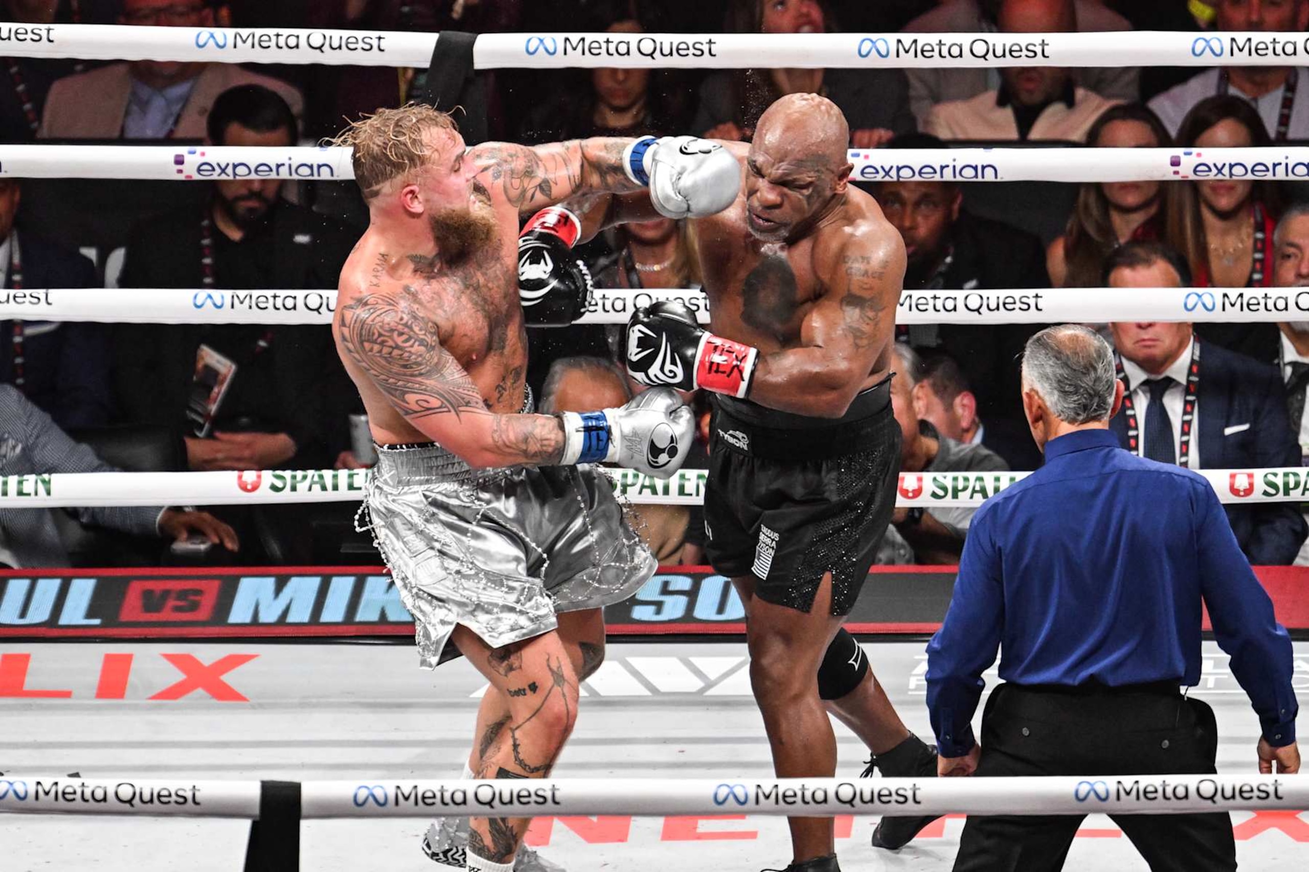ARLINGTON, TEXAS - NOVEMBER 15: Mike Tyson (in black short) and Jake Paul (in silver short) exchange punches during their heavyweight world titles of the Premiere Boxing Championship on Friday night at AT&T Stadium in Arlington, Texas, United States on November 15, 2024. (Photo by Tayfun Coskun/Anadolu via Getty Images)