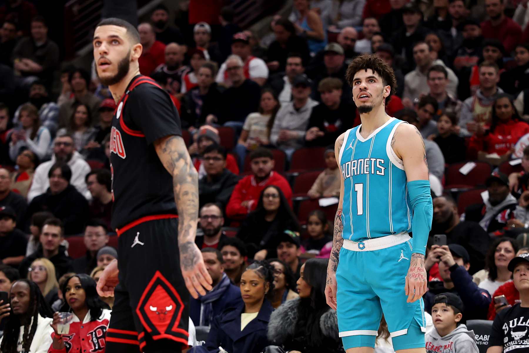 CHICAGO, ILLINOIS - JANUARY 17: (L-R) Lonzo Ball #2 of the Chicago Bulls and LaMelo Ball #1 of the Charlotte Hornets look on during the second quarter at the United Center on January 17, 2025 in Chicago, Illinois. NOTE TO USER: User expressly acknowledges and agrees that, by downloading and or using this photograph, user is consenting to the terms and conditions of the Getty Images License Agreement.  (Photo by Luke Hales/Getty Images)