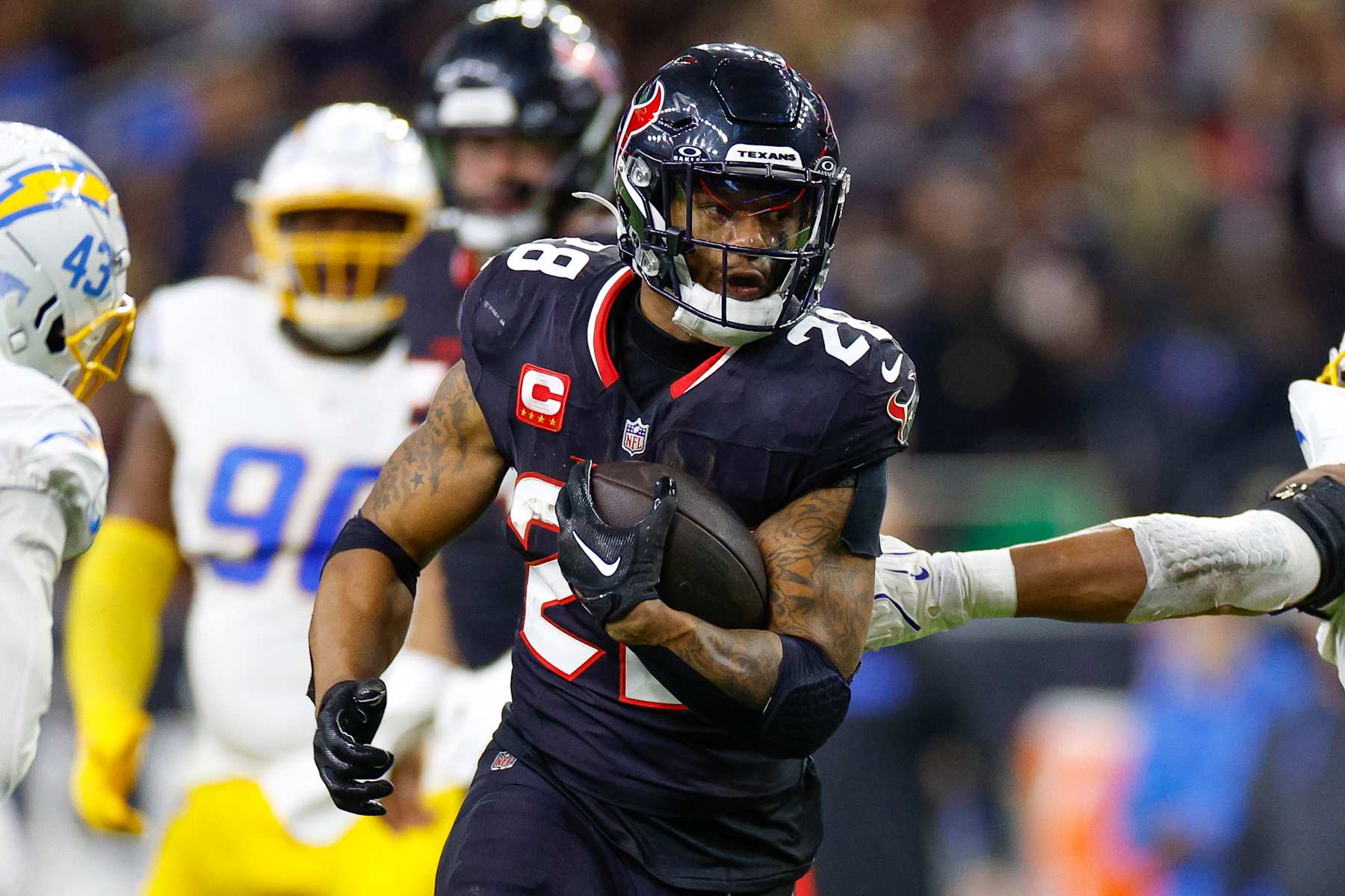 HOUSTON, TEXAS - JANUARY 11: Joe Mixon #28 of the Houston Texans carries the ball on a running play during the second half of the AFC Wild Card Playoff game against the Los Angeles Chargers at NRG Stadium on January 11, 2025 in Houston, Texas. (Photo by Brandon Sloter/Getty Images)