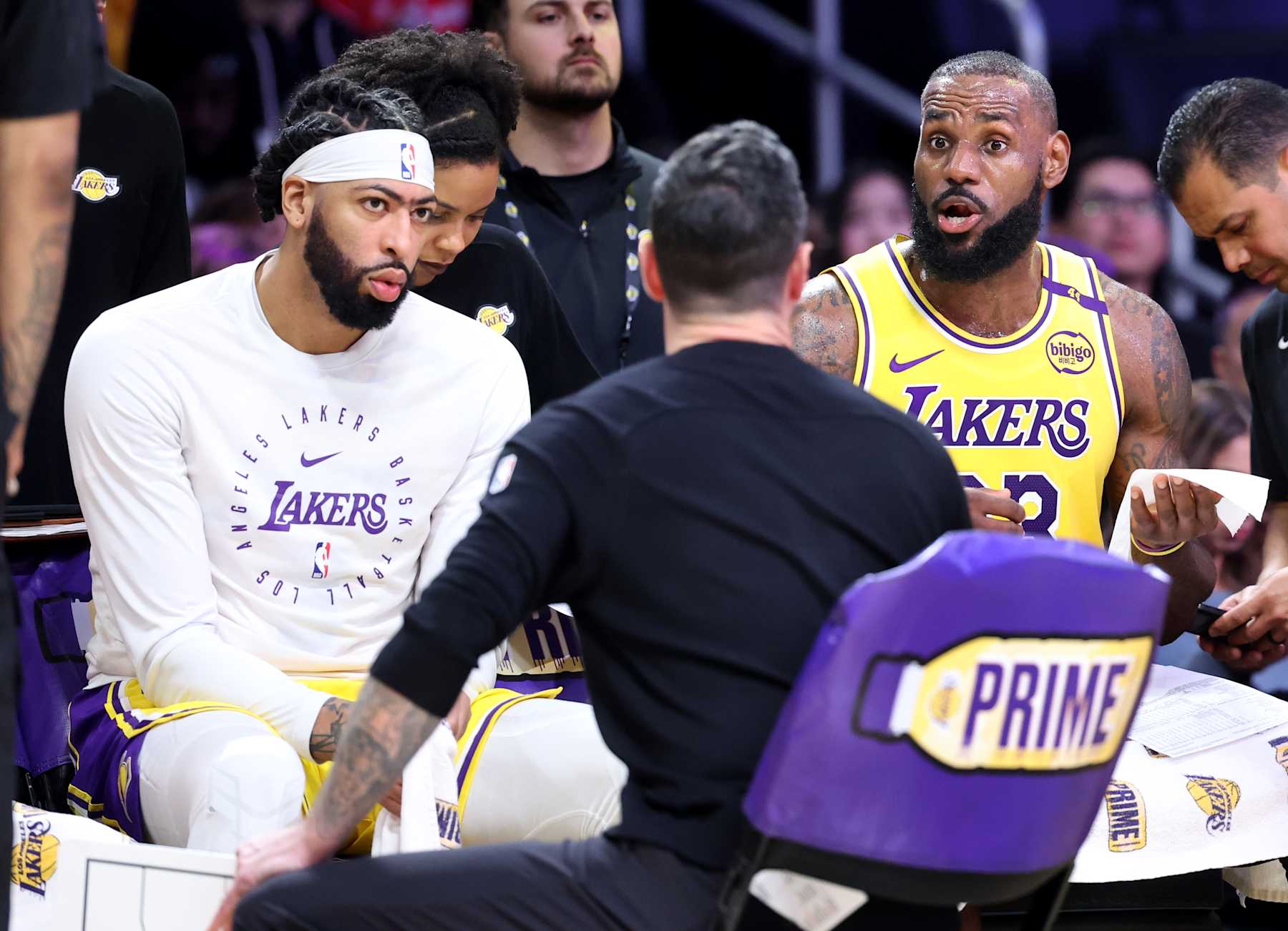 Los Angeles, California December 31, 2024-Lakers Anthony Davis, left, and LeBron James listen to head coach JJ Redick during a timeout  at Crypto.com Arena Tuesday. (Wally Skalij/Los Angeles Times via Getty Images)