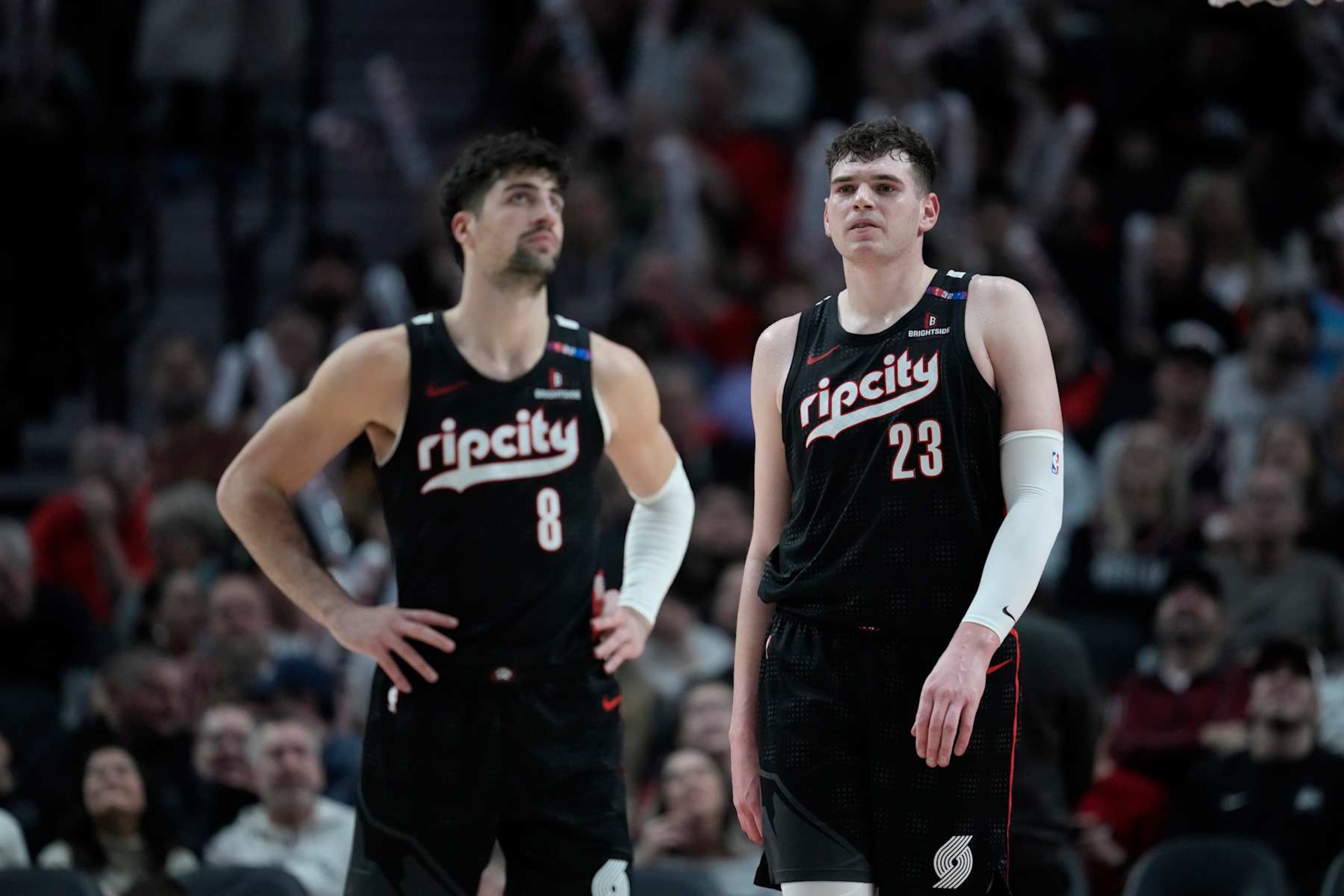 PORTLAND, OREGON - JANUARY 11: Deni Avdija #8 and Donovan Clingan #23 of the Portland Trail Blazers look on during the second half against the Miami Heat at Moda Center on January 11, 2025 in Portland, Oregon. NOTE TO USER: User expressly acknowledges and agrees that, by downloading and or using this photograph, User is consenting to the terms and conditions of the Getty Images License Agreement. (Photo by Soobum Im/Getty Images)