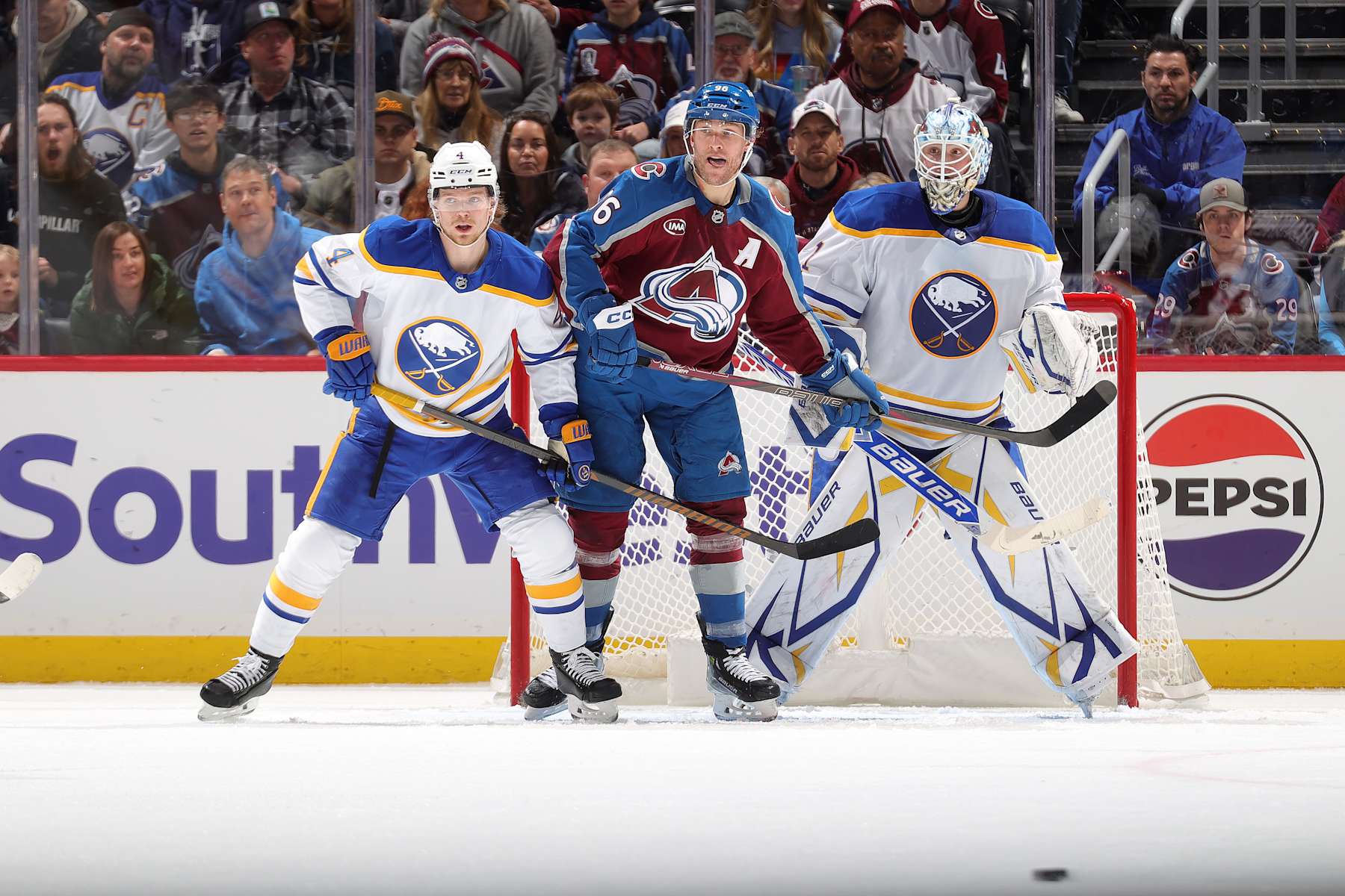 DENVER, COLORADO - JANUARY 02: Bowen Byram #4 and goaltender Ukko-Pekka Luukkonen #1 of the Buffalo Sabres defend against Mikko Rantanen #96 of the Colorado Avalanche at Ball Arena on January 2, 2025 in Denver, Colorado. (Photo by Michael Martin/NHLI via Getty Images)