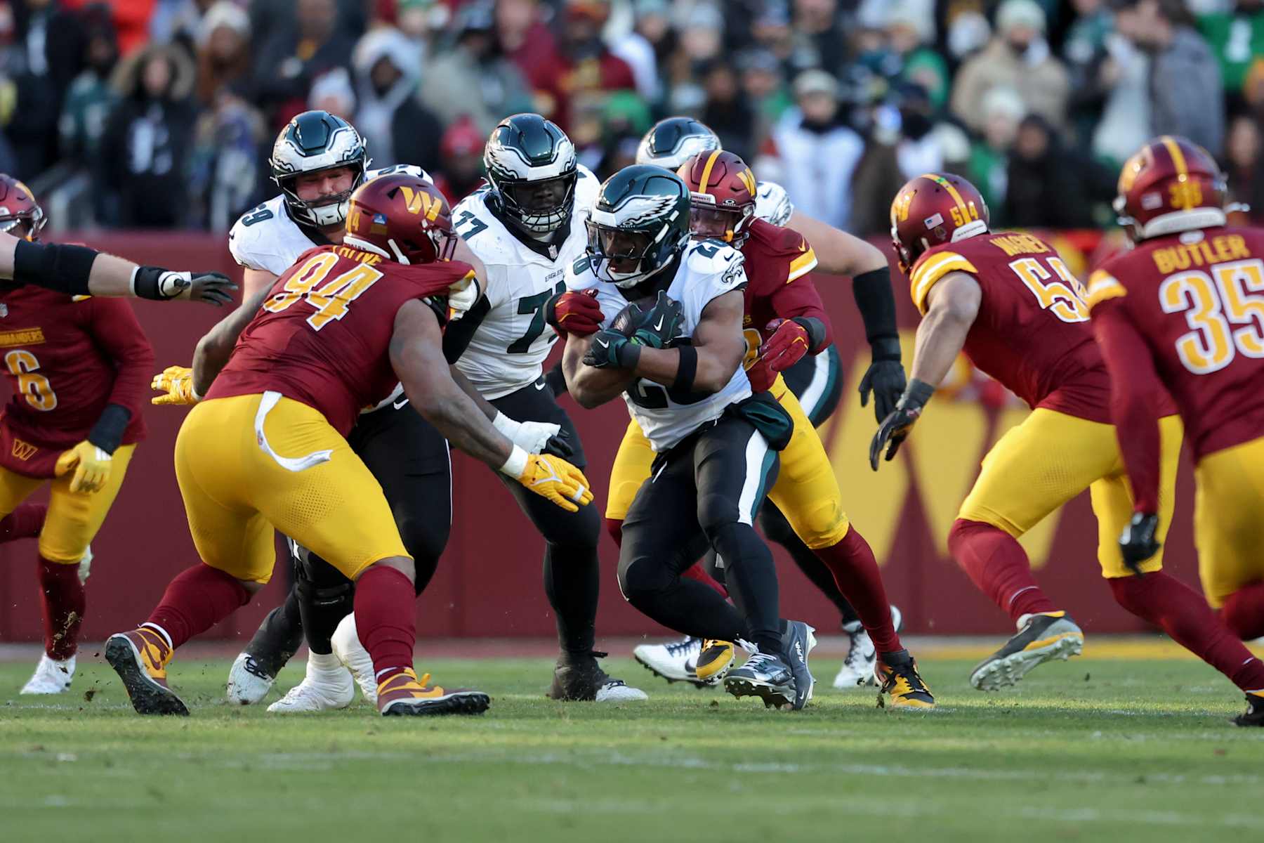 LANDOVER, MARYLAND - DECEMBER 22: Saquon Barkley #26 of the Philadelphia Eagles is tackled while running the ball during a game against the Washington Commanders at Northwest Stadium on December 22, 2024 in Landover, Maryland. The Commanders defeated the Eagles 36-33. (Kara Durrette/Getty Images)