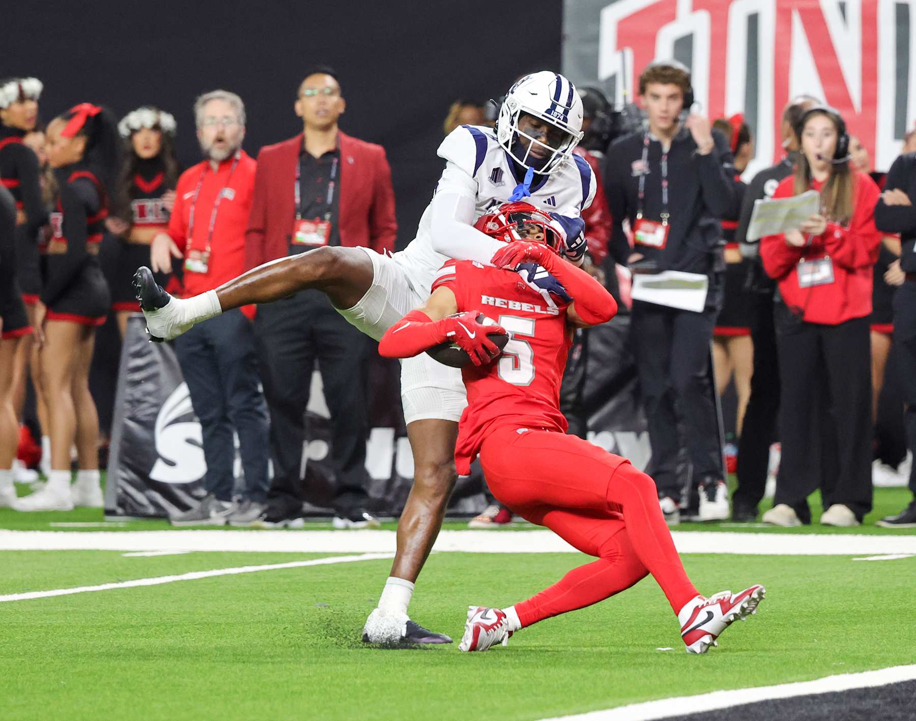 LAS VEGAS, NEVADA - NOVEMBER 30: Defensive back Cameron Oliver #5 of the UNLV Rebels intercepts a pass intended for wide receiver Cortez Braham Jr. #8 of the Nevada Wolf Pack in the second quarter of their game at Allegiant Stadium on November 30, 2024 in Las Vegas, Nevada. (Photo by Ethan Miller/Getty Images)