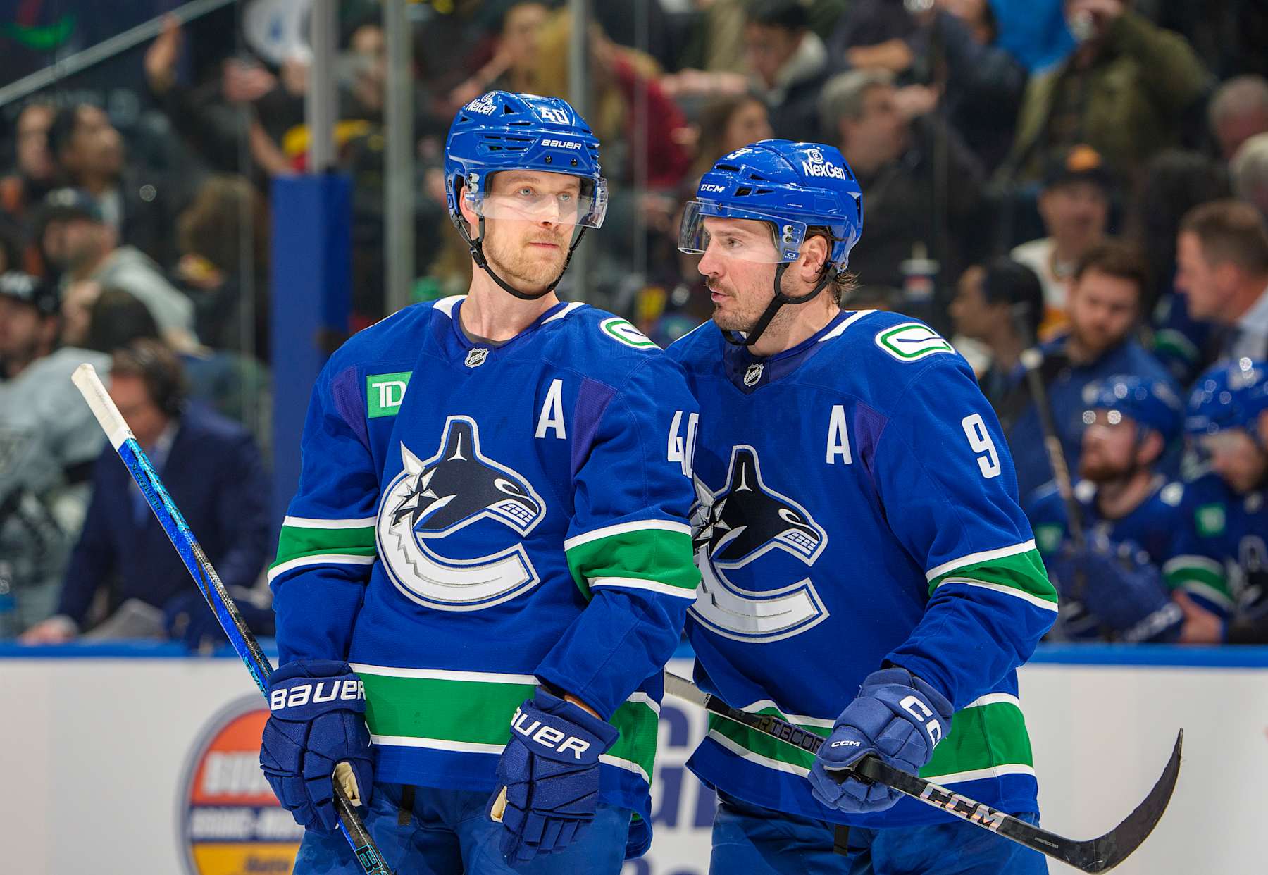 VANCOUVER, CANADA - JANUARY 16: J.T. Miller #9 and Elias Pettersson #40 of the Vancouver Canucks discuss game play during the second period of their NHL game against the Los Angeles Kings at Rogers Arena on January 16, 2025 in Vancouver, British Columbia, Canada.  (Photo by Jeff Vinnick/NHLI via Getty Images)